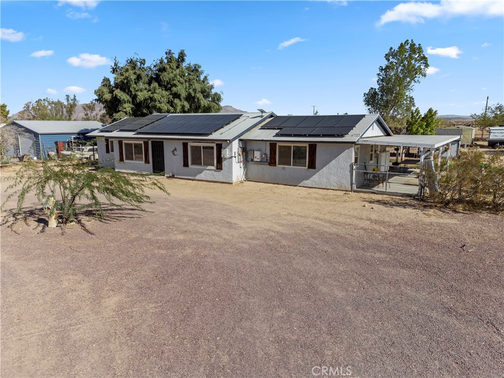 Beautiful Newberry Springs home! The photos say it all, so let's get straight to the details! 2 Bedroom, 2 Bath frame built home on 2.14 acres, fully fenced, with easy access from a paved road just off of Valley Center Rd. This home has an abundance of features including: Solar panels with battery storage (buyer to assume $208 per month lease), metal roof, laminate wood flooring, upgraded kitchen cabinets, all appliances included! The home also has butcher block countertops, central heating and air (only 3 years old), tankless water heater (endless hot water), and mature trees and landscaping on a watering timer. The property also offers ample space for outdoor activities including a large storage shed that has been converted into a craft room with lighting and air conditioning. The detached workshop has two roll-up doors and it's own separate double gated driveway. Raised flower beds and water system are available in the greenhouse that is on the property, making it easy to start your own garden. You can also bring your horses and chickens as the home has a chicken coop and horse corral. After a long day, relax on the covered back patio in the hot tub which is only 1 year old and is included in the sale. The well and septic are in great condition and the gravel driveway will make parking a breeze! It doesn't get much better than this!