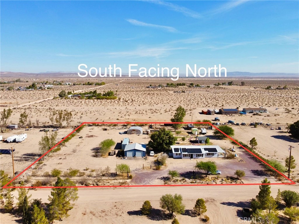 Beautiful Newberry Springs home! The photos say it all, so let's get straight to the details! Currently a 2 Bedroom, 2 Bath (originally 3 bedroom, one bedroom was converted to a living room, can be a 3rd bedroom again if you add 2 walls and a door) This is a frame built home on 2.14 acres, fully fenced, with easy access from a paved road just off of Valley Center Rd. This home has an abundance of features including: Solar panels with battery storage (buyer to assume $208 per month lease, cheaper than an electric bill and it builds equity), metal roof, laminate wood flooring, upgraded kitchen cabinets, all appliances included! The home also has butcher block countertops, central heating and air (only 3 years old), tankless water heater (endless hot water), and mature trees and landscaping on a watering timer. The property also offers ample space for outdoor activities including a large storage shed that has been converted into a craft room with lighting and air conditioning (which could also be converted to a guest house). The detached workshop has two roll-up doors and it's own separate double gated driveway. Raised flower beds and water system are available in the greenhouse that is on the property, making it easy to start your own garden. You can also bring your horses and chickens as the home has a chicken coop and horse corral. After a long day, relax on the covered back patio in the hot tub which is only 1 year old and is included in the sale. The well and septic are in great condition and the gravel driveway will make parking a breeze! It doesn't get much better than this!
Note:3rd bedroom was converted to a living area but could be restored to a bedroom by adding two walls and a door.
