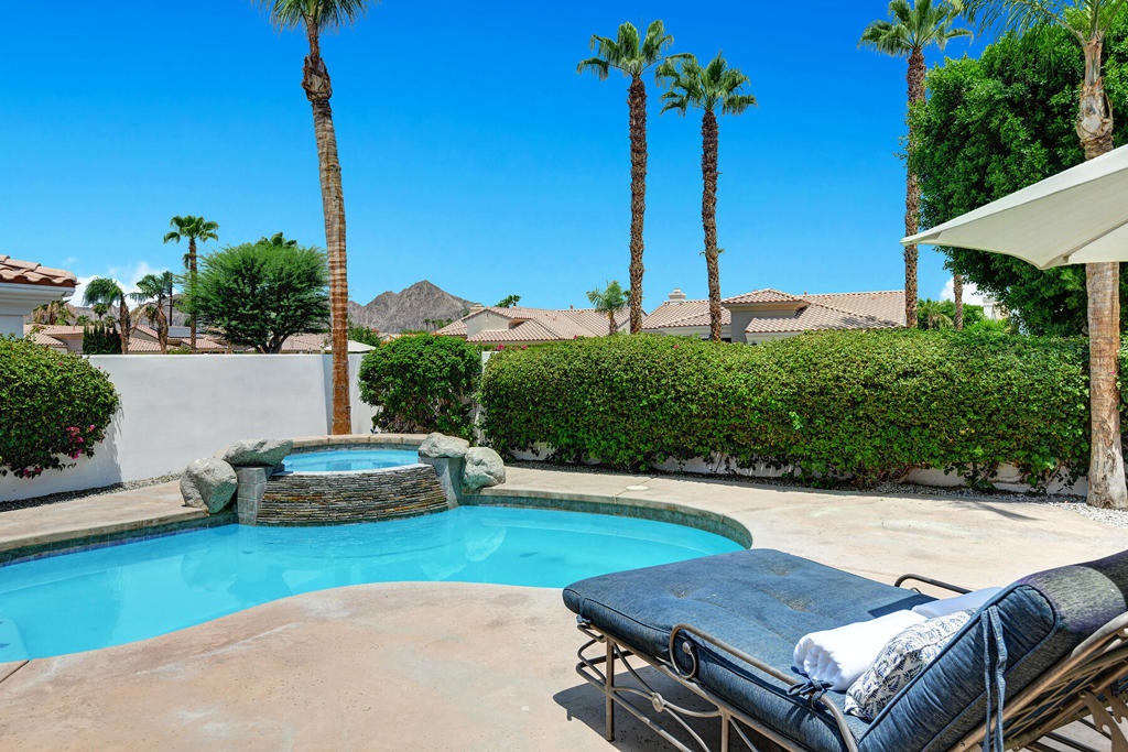 Discover modern luxury in this stunning contemporary home with captivating views, and a sparkling saltwater courtyard pool and hot tub. You'll feel the freedom of space when you enter the open-concept layout, featuring high ceilings. The updated kitchen shines with quartz countertops and a spacious walnut island with bar seating. The contemporary tile floors flow throughout and into the expansive master suite, which offers breathtaking mountain views and a luxurious ensuite with: sunken Jacuzzi tub, seamless glass walk-in shower, dual vanities, and a large walk-in closet. Two additional bedrooms, including an ensuite room with mountain views and a walk-in closet, provide ample guest accommodation. Garage flooring was just recently epoxied for a pristine finish throughout. The community includes a pedestrian gate out of the community for quick access to Old Town La Quinta or The Citrus Club golf course. Low HOA fees include a guard gate, exterior tree and yard maintenance, Internet, Cable TV and trash collection. This home is a contemporary masterpiece, blending elegance with comfort. Fully Furnished, Turnkey, ready to enjoy!