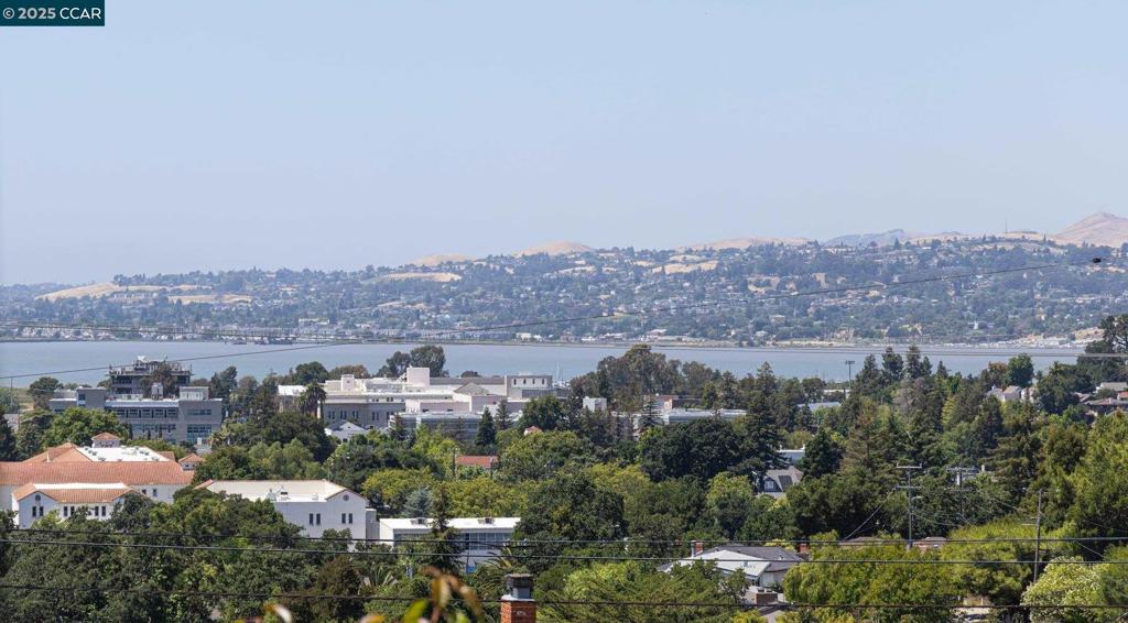 Discover a rare gem never before on the market! Nestled in the scenic hills of Martinez, this updated two-level home boasts stunning views of the Carquinez Strait. Step inside to fresh paint, luxury vinyl, hardwood, and carpet flooring. Along with an updated kitchen, garden window, and cozy dining nook. The formal dining area and spacious living room are perfect for entertaining, featuring built-ins, a wood-burning fireplace, and plantation shutters framing the panoramic views. The main level includes three bedrooms and two full baths, plus access to an upper deck—ideal for summer barbecues or sunset watching. Downstairs offers a private retreat or guest quarters, complete with a second kitchen, living room, bedroom, full bath, and direct access to a lush yard. The backyard is a gardener’s paradise with mature foliage. Imagine picking your own fresh persimmons, pomegranates, grapefruits, tangerines, lemons, oranges, and cherries. Enjoy peaceful suburban living just minutes from shops, dining, parks, and major highways. A truly unique opportunity! Views: Carquinez, Downtown