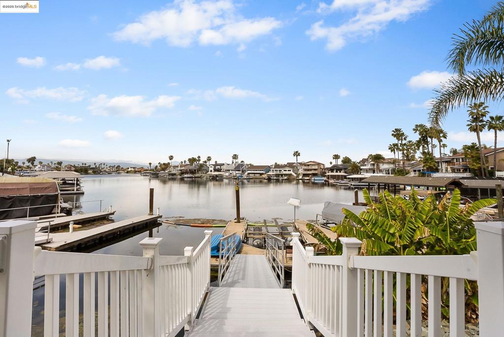 Welcome to your dream home in Sand Bay, where luxury meets the tranquil sounds of water gently lapping at your expansive waterfront. This stunning property offers unparalleled access to breathtaking views and a perfect oasis of serenity. With a breathtaking covered patio and a fully-equipped outdoor tiki hut, it's ideal for starlit entertaining. The open floor plan spills into a grand living area, featuring 4 spacious bedrooms and 3 beautifully designed bathrooms, including a separate guest suite for added privacy. Engage in family fun in the expansive great room or lively game room, while culinary dreams come alive in the entertainer’s kitchen, complete with chef’s-grade appliances and a cozy breakfast nook. Experience luxury in the master suite, which boasts a spa-like bath, a substantial walk-in closet, and a serene sitting area with sweeping bay views. Complete with a 3-car garage, this unique home promises an inviting ambiance, unforgettable memories, and captivating views at every turn. Don’t miss your chance to claim this extraordinary retreat as your own! Solar solar solar with Tesla charger station...