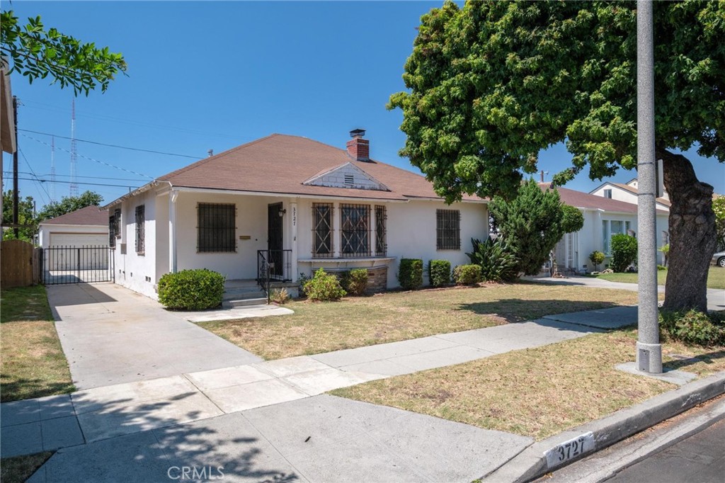 Welcome to 3727 West Blvd – a charming traditional residence in the heart of Los Angeles’ vibrant Crenshaw Manor. Set on a wide, tree-lined street, this home features 3 bedrooms, 1.5 bathrooms, and 1,280 sq. ft. of living space on a generous 6,000 sq. ft. lot. Inside, the inviting living room with its classic brick fireplace and orginal hardwood floors flows seamlessly into the dining area. The galley kitchen offers ample space and includes a convenient laundry area. Just beyond, you’ll find a half bathroom and a versatile den—ideal as a third bedroom—with direct access to the spacious backyard. Two additional bedrooms and a full bathroom complete the thoughtful floor plan. The backyard offers endless potential, with a long driveway and a detached 2-car garage—perfect for future ADU conversion. Ideally located, this home places you near USC, Culver City, Downtown LA, Koreatown, and West LA, with easy access to dining, arts, and culture. Local favorites include Highly Likely, Cento Pasta, and Alta Adams, as well as Whole Foods and the shops of Downtown Culver City. With the new Metro Crenshaw (K) Line, you’re minutes from LAX and SoFi Stadium, making Crenshaw Manor one of LA’s most connected communities. Whether you’re looking to restore its timeless charm or reimagine the space entirely, this is a rare opportunity to plant roots in one of Los Angeles’ most desirable neighborhoods.