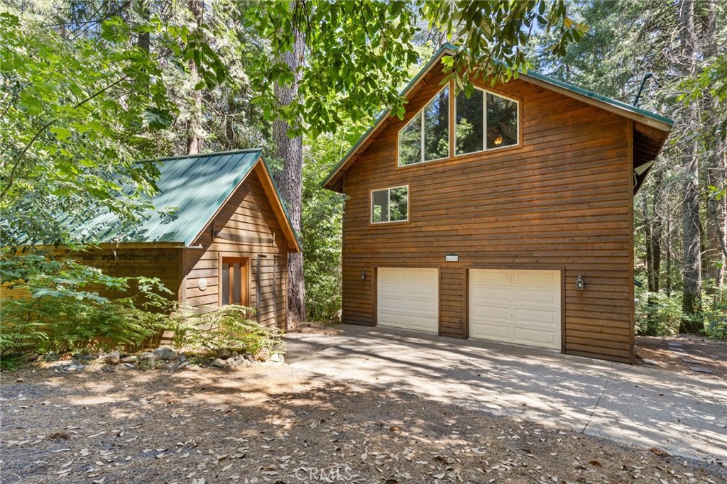 Mountain retreat on 5+ acres with stream, trails and spectacular workshop!
Escape to this one-of-a-kind mountain retreat nestled on over 5 private, peaceful acres, featuring a year-round spring-fed stream and direct access to miles of recreational land. Adjacent to Sierra Pacific land, this property offers endless opportunities for hiking, biking, trail riding, and exploring the great outdoors—plus access to flumes and popular trail systems right across the street as well as Paradise Lake and Lake De Sabla just minutes away.
The beautifully maintained home combines rustic charm with modern updates, including renovated plumbing and electrical systems and thoughtful additions in 2003 and 2010. A durable metal roof covers the main home, an oversized finished pump house, and a truly spectacular woodworking shop. The shop is a dream for hobbyists or professionals alike, complete with a garage door and wood stove to keep the creative energy flowing through the winter months.
Inside the main home, you'll find two bedrooms, three bathrooms, and two cozy lofts, offering flexibility for guests, family, or work-from-home needs. Multiple living spaces invite relaxation, while a stunning year-round glass room immerses you in the surrounding forest—bringing the outdoors in no matter the season.
The chef’s kitchen is a showstopper: fully remodeled with granite countertops, soft-close cabinetry, and a high-end 6-burner range—perfect for everyday cooking or entertaining. Covered decks on both sides of the home offer quiet spaces to relax, entertain, or simply listen to the stream flowing nearby.
The finished pump house offers additional storage and a versatile space that could easily be transformed into a hobby room, art studio, or remote office. Other bonuses include generator hookups and a small generator, cell phone booster, and beautiful appliances included.
A standout feature is the separate living space above the two-car garage—ideal for multi-generational living, guest quarters, or potential rental income. With its separate entrance, this bonus space includes a large living area, kitchenette, massive primary suite, and loft.
Whether you're searching for a serene full-time residence, a vacation getaway, or an income-producing property, this mountain gem delivers privacy, functionality, and inspiration in equal measure. **Don't miss the video walk through**