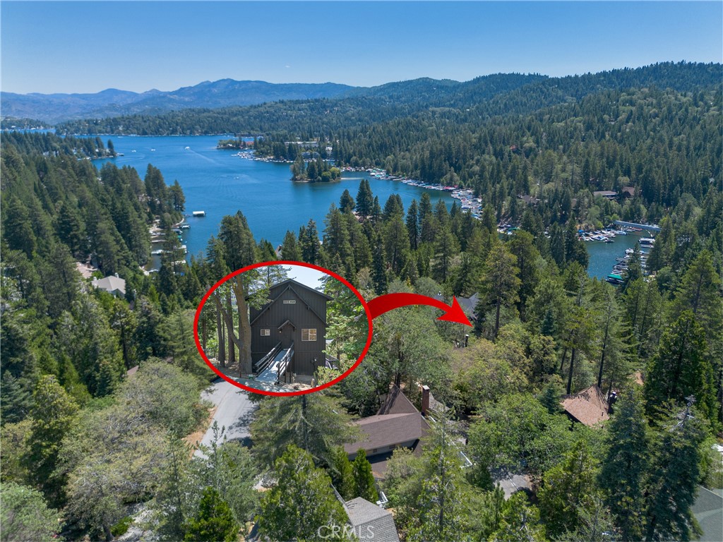Location, location, location! Walk to the shoreline of Lake Arrowhead or to the charming town of Blue Jay from 164 Birchwood Dr. Tucked in the forest yet just one block off the main road you will find this stylish lodge style home. Featuring 3 bedrooms (plus a bonus room that's easily a 4th) and 3 full bathrooms, you will feel like you have space for the whole gang to spread out. Use it for yourself or as an investment; it's got proven rental income from an STR permit already!
The main floor of the cabin is where you enter. Soak up the huge view from a two story wall of picture windows. Relax by the crackling fireplace and watch the snow fall around your cozy retreat. Or sit on the deck and look out over Blue Jay Bay on beautiful, private Lake Arrowhead. Large living room/dining room are adjacent to the kitchen, which has been remodeled with craftsman flair. There's a main floor bedroom and full bathroom. Upstairs are two bedrooms and bathroom featuring a claw foot tub to soak in. The lowest level of the house is accessed from inside or outside, if you prefer to utilize it as a separate unit. Make it a game room, bunk room or family room or turn it into a stand alone studio. A large wrap around deck invites you outside to enjoy serene the tree view.
This great new listing can be purchased mostly furnished, allowing you to enjoy it from day one!