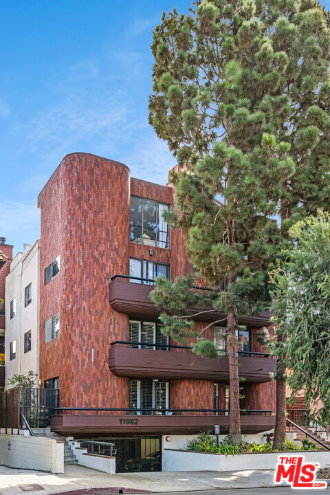 Stylish living awaits! Single level 2 bedroom + 2 bath condominium well located between Wilshire and San Vicente just East of Bundy in Brentwood. Front facing second floor unit opens to living room + dining room with gas fireplace and doors that lead to private terrace. Large living area opens to recently updated kitchen with breakfast area. Primary suite boasts a large walk-in closet and newly remodeled en-suite bathroom accented with glass tile and gleaming fixtures. Second bedroom, hallway bath and laundry closet with full size side by side W/D complete the unit's floor plan in 1,371 SqFt. Brand new HVAC and ducting completed within the last year. Outside entry into the single level unit. The 1982 building is located on a quiet tree lined block. Wood laminate flooring featured predominantly throughout the living space with bedrooms carpeted. Storage options abound with extra closet n the foyer entry and a private storage closet located within the building. 2 parking spaces, one within the garage and one located directly behind the building. Building is well maintained with many upgrades completed within the last two years, making it a solid investment. HOD includes EQ insurance, water and gas utilities.