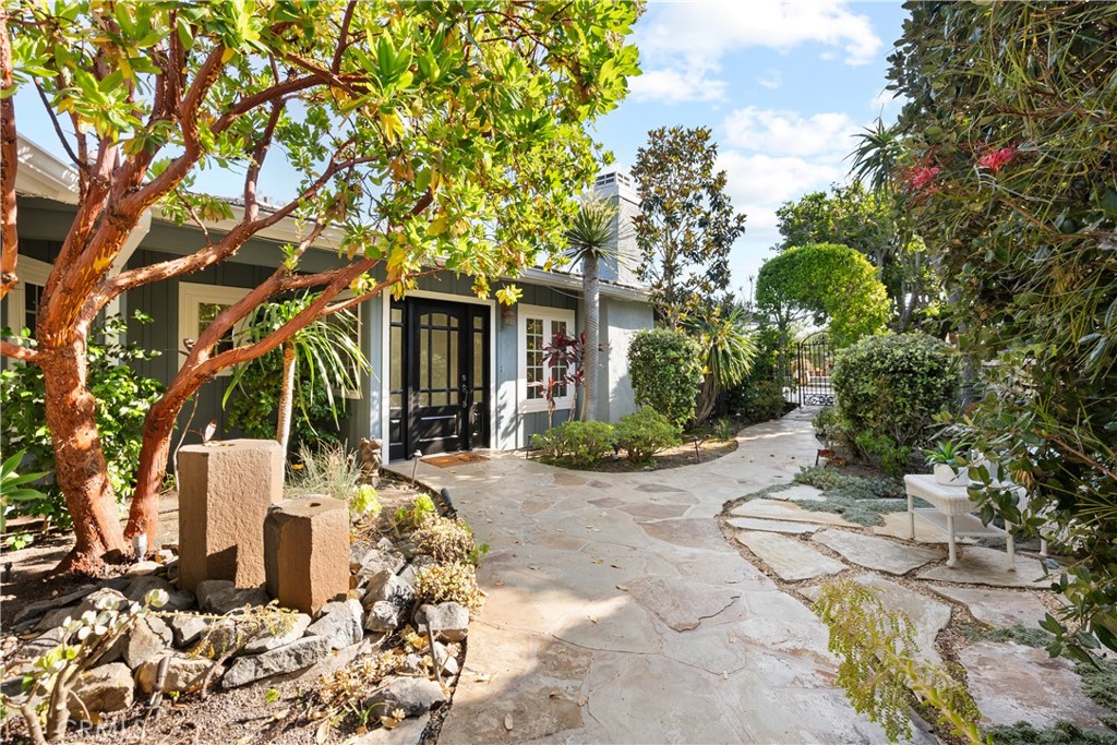 Tucked away in the serene, gated community of Candlelight Hills, this beautifully maintained single story home offers an exceptional blend of comfort, functionality, and outdoor luxury. With nearly 3,000 square feet of living space, four bedrooms, four bathrooms, an office, and sweeping mountain views, this home is a private retreat designed for everyday living and effortless entertaining. Step inside to find soaring vaulted ceilings, skylights that flood the space with natural light, and two inviting family rooms anchored by both gas and wood burning fireplaces. The heart of the home is the kitchen, equipped with dual ovens, a five burner gas cooktop with grill, two dishwashers, a wine fridge, and an ice machine. The adjacent dining spaces offer flexibility for formal dinners or casual meals, while the separate office provides a quiet place to work or study. The primary suite overlooks the backyard and pool, complete with its own walk in closet, dual vanities, and outdoor access. Three additional bedrooms are thoughtfully located near the front of the home. Two of them open to a charming wraparound porch, and one makes a perfect nursery or guest room. An outdoor bathroom and shower provide added convenience just steps from the pool. Outside, the backyard delivers the ultimate California lifestyle with multiple shaded seating areas, a built in gas BBQ, bar with seating, mini fridge, and space for alfresco dining. The raised garden bed, placed behind the office, adds a peaceful touch to the lush setting. The home includes a fully paid 38 panel solar system that powers both the house and pool. The three car garage features an EV charger for added convenience. A Ring camera security system offers peace of mind, while the home’s water filtration and hot water recirculating systems add to its efficiency and comfort. Located just off the 15 freeway with convenient access to both Escondido and Rancho Bernardo, this turnkey property offers privacy, style, and an ideal indoor outdoor flow.