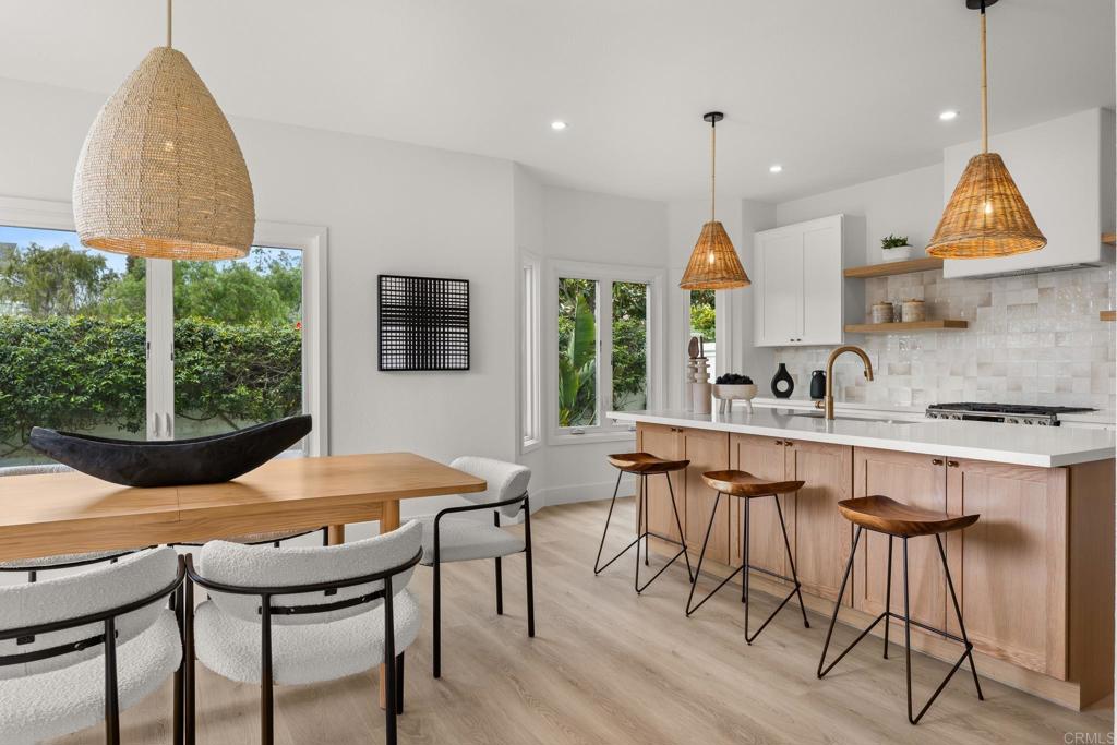 Step into this stunning, fully remodeled home in the exclusive, gated enclave of Laguna Shores—just 26 residences nestled in a private cul-de-sac. With a coveted south-facing orientation, this home is bathed in natural light and showcases serene views of the Agua Hedionda Lagoon and Carlsbad hills. Renovated by San Diego design-build firm Rice Interiors, you'll find a thoughtfully reimagined interior featuring an open, airy layout with dramatic volume ceilings, skylights, and transom windows. The brand-new kitchen, with two-tone white and oak cabinets, zellige tile, large island, custom range hood and all new LG appliances, is a showstopper—perfect for entertaining—while all three bathrooms have been beautifully redesigned with modern vanities, Delta Champagne Brass plumbing and natural tiles. Luxury flooring flows throughout, complemented by upgraded Milgard windows and doors. The versatile floor plan includes a spacious bedroom and full bath on the main level, while upstairs boasts dual primary suites. A sculptural, renovated circular staircase adds architectural elegance, and the floor-to-ceiling fireplace creates a cozy focal point. Enjoy direct access to Agua Hedionda Lagoon trails and preserve, plus close proximity to top-rated schools, shopping, services, freeway access, and the Pacific Ocean. This is a rare opportunity to own a designer-upgraded home in one of Carlsbad’s most sought-after gated communities. Come tour this exceptional property—you just might fall in love.