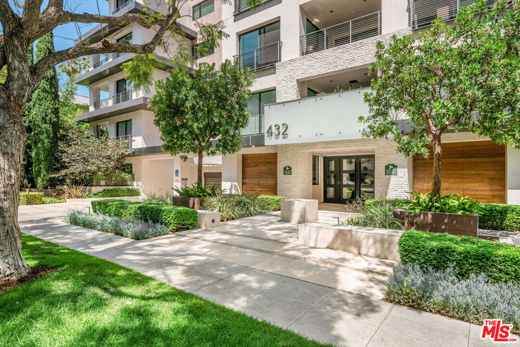 Welcome to this stunning designer owned, front-facing residence in Beverly Hills' most prestigious boutique building. Offering the comfort and feel of a private home, this stunning and spacious condominium features thoughtfully designed interiors that open to your own large, wraparound patio and lush garden. Complete with a gas BBQ, the combined space invites relaxed California living and effortless indoor-outdoor entertaining. Inside, wide-plank hardwood floors and floor-to-ceiling Fleetwood sliding glass doors frame garden views from nearly every room. The chef's kitchen stuns with Italian cabinetry, Caesarstone counter-tops, a large island with bar seating, Miele appliances, and a 48" Sub-Zero fridge. Motorized window treatments add effortless elegance throughout. The ideal layout features a tranquil primary suite with a large walk-in closet and spa-style bath with soaking tub, dual vanities, and lovely frameless glass enclosed shower. A second en-suite bedroom, powder room, and full laundry room complete the space. Enjoy three side-by-side parking spots with an electric car charging station, a private storage unit, and luxury amenities including 24/7 concierge and security, video-secure entry, gym, conference room, and chic lounges. Located in the heart of 90210 with Beverly Hills city services, top public schools, and world-class dining, shopping, and culture just moments away.