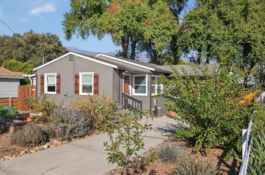 Located in the heart of Ojai's charming village, this versatile property includes a detached ADU along with a main residence full of comfort and character. The home offers three inviting bedrooms, a thoughtfully updated bathroom, and an open-concept kitchen with granite countertops and stainless steel appliances. A welcoming living room with built-in bookcases invites quiet relaxation, while interior laundry, central heating and air conditioning, and dual-pane windows ensure everyday convenience.Privately tucked away, the ADU provides a peaceful retreat--an airy studio-style space with its own bedroom, bathroom, kitchen, and living area--ideal for guests, extended family, or income potential. Outdoors, the generous front garden features raised beds for homegrown herbs and vegetables and great views of the Topa Topa mountains, while the backyard includes a chicken coop, fire pit gathering area, and spacious patio shaded by a majestic tree. Energy-efficient features include dual-pane windows, central heat and air, plus an EV charger already installed. All just moments from Ojai favorites like The Dutchess, Ojai Coffee Roasters, Libbey Park, and the Farmer's Market, this property blends community, sustainability, and village living.