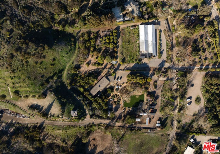 Tucked away in Malibu's iconic Bonsall Canyon, this nearly 10-acre regenerative farm is where architectural design, ecological integrity, and coastal living meet in perfect harmony. The lovingly restored mid-century modern residence offers timeless character, ideal as a guest house while you create your dream home, or take advantage of the approved Marmol Radziner-designed plans for over 10,000 sq. ft. of extraordinary greenhouses and a courtyard. With 800 fruit and nut trees, guest and artist studios, and even the very spot where Joan Didion penned part of The White Album, the property is a rare sanctuary for both creativity and connection. Designed for inspired farm-to-table gatherings, equestrian pursuits, or simply living in balance with nature, this one-of-a-kind estate is a once-in-a-generation opportunity minutes from Zuma Beach, yet a world apart.