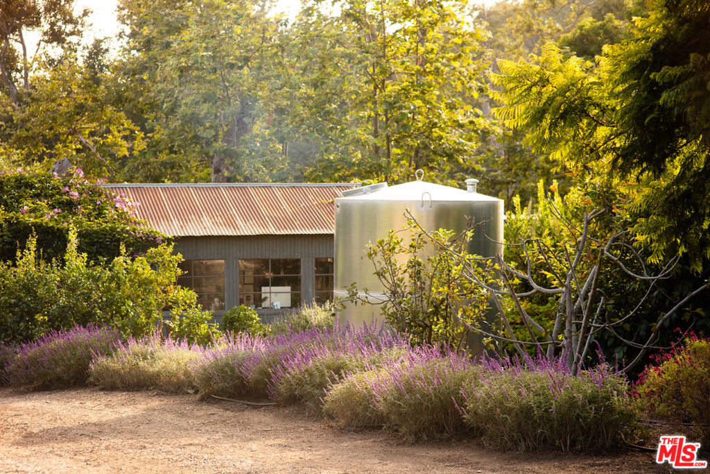 THE BIGGEST LITTLE FARM HERE IN MALIBU! A RARE REGENERATIVE FARM in BONSALL CYN :)* On nearly 10-acre estate across two parcels in iconic Bonsall Canyon* Located just minutes from Zuma Beach* Private and serene setting with lush orchards, a mid-century modern home, with equestrian potential.Main Residence & Additional Structures:* Restored mid-century modern home with:* Walls of glass and high-beamed ceilings* Artisan-made tiles and sinks* Open floor plan for seamless indoor-outdoor living* Large stone fireplace and hardwood floors* Sauna and ice bath, as well as outdoor tub and shower* Rainwater collection* The detached guest house, known as the apothecary, is currently used as a private office* There is a detached kitchen for parties, cooking demos, or education* Artist/writer's studio overlooks the estateLand & Natural Features:* Expansive orchard with 800 fruit and nut trees, including:* Avocados, macadamia nuts, apples, pears, peaches, plums, apricots* Mandarins, oranges, guava, pomegranates, cherimoya, and more* Seasonal creek runs through the property, surrounded by majestic sycamores and oaks* Richly restored and maintained without chemicals to support ecosystem healthAgricultural & Equestrian Potential:* Two large greenhouses, home to the family-run Zuma Orchids since the 1970s. Where Joan Didion wrote the last chapter of "The White Album".* Corrals, storage sheds, additional space, plus goats and chickens* Flat pad on upper section of propertyOpportunities & Potential:* Secluded yet conveniently close to shops, restaurants, and amazing Malibu schools* A rare chance to own a stunning, eco-conscious Malibu sanctuary* MARMOL-RADZINER PLANS FOR 3 GREEN HOUSES, APPROX. 10,000 SQ FT, PLUS 300 SQ FT COURTYARD