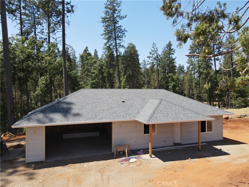 If you are looking for a fantastic mature forest in your back yard then this might just be the place. Spacious .82 ACRE lot thats runs down close to the creek. Imagine Sitting under the covered back patio and enjoying the mature trees and privacy. This stunning 2 bedroom, 2 bathroom home built by local Builder Frost Construction is now available for sale! Owned Solar 3.04 KW system. New Complete Septic System! Boasting a generous 1,021 square feet of living space, this home features top-notch craftsmanship and modern amenities. Upon entering, you'll be greeted by a charming 96 square foot covered front porch with knotty pine tongue & groove ceiling, recessed lighting and a craftsman-style front door and custom shutters. Step inside to discover an open floor plan that seamlessly connects the living room, kitchen, and dining area. The kitchen is a chef's dream with granite countertops, stainless steel appliances, recessed LED and pendant lighting, pantry and a stylish island for added convenience. The primary bedroom is a serene retreat with crown molding, a slider leading to the walkway to the spacious covered patio with ceiling fan, and a well-appointed en-suite bathroom featuring granite counters and a step-in shower. The guest bedroom also offers crown molding and access to a sleek guest bathroom with granite countertops and a tub/shower combination. This home is equipped with an 8-panel owned solar system for energy efficiency and features gorgeous Vinyl Plank flooring throughout. Outside, you'll find a spacious 114 square foot covered patio with recessed lighting and a ceiling fan, perfect for outdoor entertaining. RV, Boat or Trailer Parking over 30 ft in length and 13 ft. wide. Fantastic Opportunity. Additionally, the oversized two-car garage, measuring 23'5" wide by 25'10" deep, includes a laundry area and plenty of space for a boat, trailer, or RV parking. Don't miss out on the opportunity to call this beautiful home yours!
