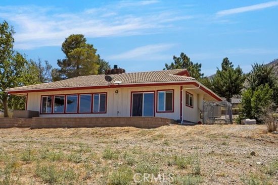 WELCOME TO JUBILEE RUN RANCH-a secluded 5-acre retreat with panoramic views, beautifully remodeled and move in ready. Discover a hidden gem nestled beside the iconic Devil's Punchbowl, offering a 350-mile vista of the Antelope Valley. This exclusive property lies within a secure gated community, accessible via a paved main road and a semi-private country lane thru 2 automatic gates-ideal for privacy and remote working. PRIME LOCATION: Just 20 minutes from Palmdale and 14 Fwy; convenient access to 15 Fwy, Victorville and even Las Vegas; and minutes from the renowned Crystalaire Golf and Country Club. NATURAL BEAUTY MEETS MODERN COMFORT-5 acres of mostly flat private land close to the Angeles National Forest and surrounded by mature shade trees. Jubilee Run Ranch boasts direct access to the Devil's Punchbowl and endless wilderness trails in the San Bernardino Mountains. Jubilee Run Ranch is fully fenced. REMODELED LIVING SPACES: the 1,824 sq ft home was thoughtfully remodeled in 2022 and features: expansive living/dining area maximizing million-dollar views w/cozy wood-burning stove; blackout curtains-perfect for a home theatre. Fully updated custom kitchen with premium appliances including Wolf 36" induction range, convection over/microwave combo, 3 rack high end dishwasher, reverse osmosis water filter, french door fridge with 2 drawer freezer. Premim Cambria quartz countertops. Soft closing drawers and doors in every custom cabinet for easy access. Glass encclosed, walk in shower with high end rain shower head. Stylish wide plank wood and tile flooring. Tons of storage throughout the house. VERSATILE AMENITIES: Two 50-amp RV hookups and RV dump station; two large RV or agricultural equipment shelters-convertible to stables; 2 air conditioned/heated office spaces plus storage/tack room-each 110 sq ft plus loft space; dedicated parking area; and wraparound stamped concrete patio, with fiber additive to prevent cracking. Watch stunning sunrise/sunset views.