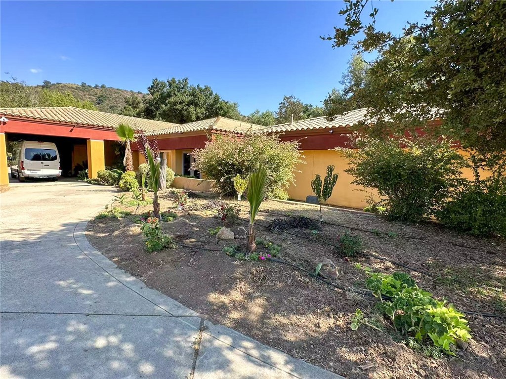 Experience ultimate privacy and elegance in this stunning custom estate located in the highly sought-after De Luz area, just minutes from vibrant Temecula. Nestled at the end of a cul-de-sac with private road access, this fully furnished 5-bedroom home sits on 5.14 acres of beautifully landscaped grounds with a serene creek running through the backyard. A grand circular driveway welcomes you to a covered entry patio and impressive double-door entrance. Inside, you'll find a spacious formal dining room adorned with a dramatic chandelier, perfect for entertaining, alongside a formal living area ideal for gatherings. The open-concept kitchen features a large center island and seamlessly flows into an expansive family room filled with natural light from numerous windows. Built-in cabinetry provides ample storage, and a stylish wet bar adds a touch of sophistication. Retreat to the luxurious master suite, thoughtfully designed for relaxation with stone countertops, a generous soaking tub, and a spa-inspired layout. Additional highlights include a large laundry room, a scenic back patio, and a massive garage accommodating up to 8 vehicles with two oversized doors. Enjoy the best of Temecula Valley living with close proximity to top-rated schools, shopping, dining, world-renowned wineries, golf courses, and parks. This remarkable estate offers an unparalleled lifestyle—schedule your private tour today.