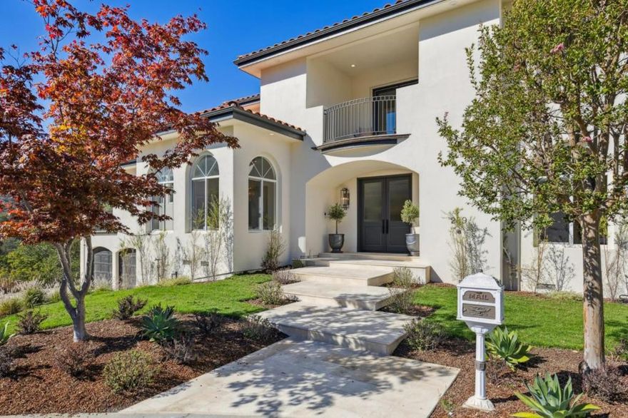 On a hilltop cul-de-sac in prestigious Hyde Park Estates is a Modern Mediterranean-inspired home with a commanding view of Devonshire Canyon. One of only 18 custom homes in the development, this luxury home was built in 1997 and recently upgraded, creating a striking balance of welcoming luxury and cozy grandeur. Light-filled rooms with elevated ceilings, arched windows and doorways, layered lighting and wide-plank, white oak floors combine for architectural elegance.   Spanning two levels, the home offers exceptional living spaces, including a living room with arched windows, box-beam ceiling and beverage bar, a sizeable kitchen and family room for entertaining on any scale, formal dining room with an eye-catching chandelier, and a luxurious primary suite with fireside sitting room and island walk-in closet. Accommodations include two suites, one on each level, and two bedrooms with a Hollywood bathroom. Enjoy outdoor terraces on each level of the home and a ground-level patio in a private, natural setting. This location is within 2.5 miles of Downtown San Carlos, scenic local parks and hiking trails, highly rated schools, the train station and Hwy 101.