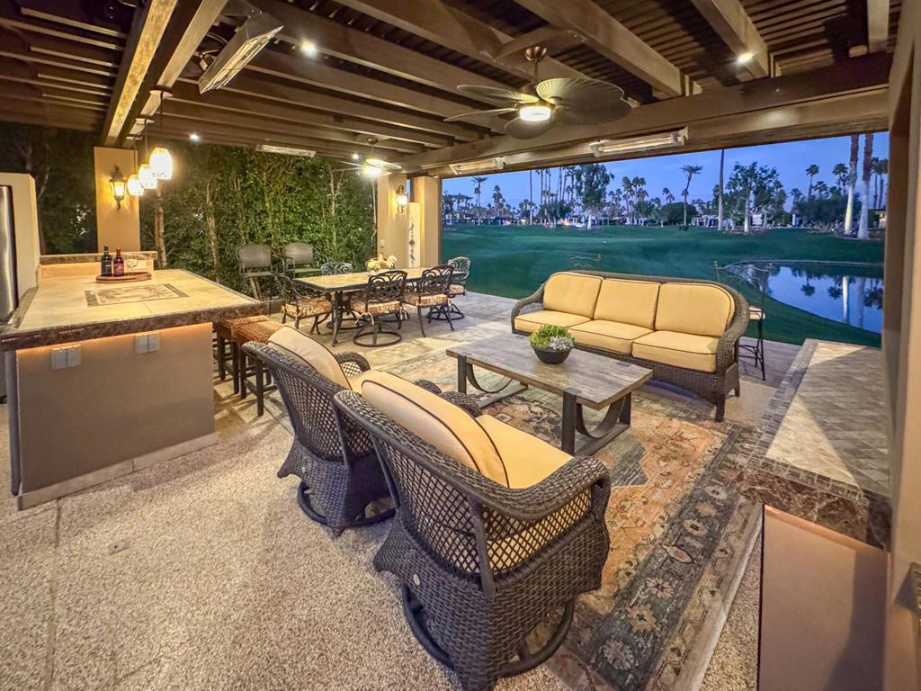Wake up to breathtaking golf course views from this expansive 3,045 sq. ft. luxury RV lot, where every detail has been meticulously designed for comfort and style. Start your morning with coffee at the elegant breakfast bar before heading straight onto the course for a round in the fresh air. The large U-shaped outdoor kitchen, complete with a spacious island, two built-in bars, custom tile counters, and stainless steel appliances, including a full-size fridge, offers a chef's paradise for entertaining. Thoughtfully landscaped and featuring a surfaced RV pad with a unique design, this lot is both stunning and functional.At the heart of this exceptional property is a sprawling L-shaped pergola with a metal roof, providing a private and serene retreat. Relax in the fully furnished outdoor living area, featuring a built-in fireplace, outdoor entertainment center with 65' TV, and ambient rope lighting around the kitchen. Enjoy the comfort of three ceiling fans, built-in heaters, and abundant lighting to set the perfect mood. The tile baseboards add an extra touch of sophistication, proving that the smallest details matter. Located in a peaceful cul-de-sac with ample parking and easy back-in access, this 2023-built luxury lot offers the ultimate resort lifestyle with privacy, elegance, and unparalleled golf course views.‍Outdoor Resort Indio is a class A only RV resort in Indio, CA.