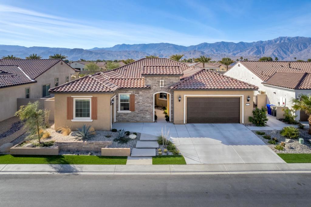 Experience luxury living in this stunning and sought-after Journey model floor plan featuring 2 bedrooms and a den. This nearly-new home combines modern elegance with ultimate comfort. A cascading wall of glass in the living room showcases the expansive mountain views and floods the space with natural light, complimented by 12' ceilings. Designer touches include a gorgeous powder bath, reimagined dining room, custom wallpaper, backsplash, fixtures and lighting, to name but a few! The open concept floor plan seamlessly connects the living and dining rooms and kitchen making it ideal for entertaining or everyday enjoyment. Step outside to your private paradise and be wowed by the phenomenal mountain views, picture perfect sunsets, sparking pool and spa, built-in barbecue and multiple seating areas. Enjoy outdoor living with minimal upkeep, thanks to the home's low maintenance design. Eco-conscious buyers will appreciate the OWNED SOLAR system and tankless water heater that keep energy costs low. Epoxy-coated garage floor, custom built-in primary closet and premium finishes all add to this home's amazing appeal!This residence boasts over $200,000 in upgrades!! Come enjoy the Del Webb active lifestyle that features tennis, pickle ball, swimming, fitness center, putting green and clubhouse which plays host to special events and activities year-round. Schedule your private showing today!!