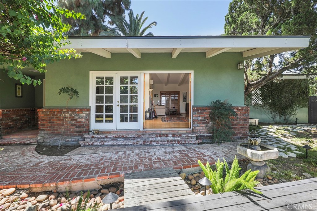 Quiet, private 3BR, 2BA home of 1914 square feet, south of Ventura Blvd with a delightful view of the valley and mountains beyond is close to fine dining and convenient shopping, with easy access to the expanding development of Warner Center, The Village, and Westfield Topanga Mall. This home boasts many desirable architectural features. Charming brick walkway and exterior veneer lead you through French Doors into the Great Room with vaulted wood-beamed ceiling, hardwood floors, impressive stone fireplace and a formal-size dining area. Kitchen has a French Country feel with custom skylight, tile counters, terra cotta floor, and an inviting breakfast nook. 3 large bedrooms include the ensuite Primary with walk-in closet and bathroom. The other 2 bedrooms are of ample size with excellent closet space. Relax on the deck outside while gazing upon the delightful view. An oversized 2 car garage leads to a covered breezeway for private entry into the kitchen and could possibly provide space to expand the kitchen and great room. Well maintained, some recent improvements include: 2 year new roof, termite clearance in April 2024, and HVAC replaced approximately 6 years ago. Your designer vision and a little work will bring this home up to its full potential and make this your gem of a home for years to come.