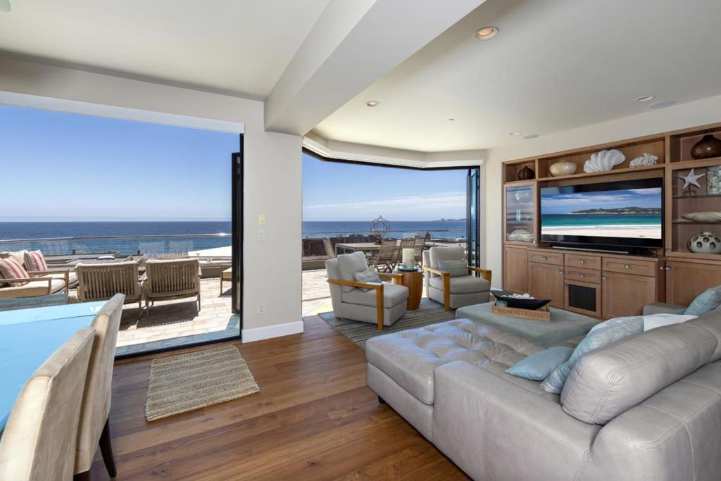 Welcome to a beautiful home in the prestigious, gated community on Beach Dr in Aptos. This spacious residence spans 2550 square feet and is situated on a generous lot of 4,835 square feet. The home offers three bedrooms all with ocean views and three full bathrooms, one half bath,making it perfect for families or those who love to entertain and be only 50 feet from the sand. The kitchen is a focal point, equipped with modern amenities that cater to all your culinary needs. The property features radiant floor heating, ensuring warmth and comfort throughout the colder months. The expansive glass, retractable doors bring the feel of the ocean into your home. While the home does not have cooling, the radiant heat and coastal climate provide a pleasant living environment. The family room is separate, allowing for cozy gatherings and large sofa bed for an extra sleeping room. For convenience, there is a dedicated laundry area, and the home is located within the Pajaro Valley Unified School District. The house also includes two (1 car ) garage spaces, providing ample room for parking and storage. This Aptos gem combines functionality with comfort, ideal for anyone looking to settle in this vibrant community.