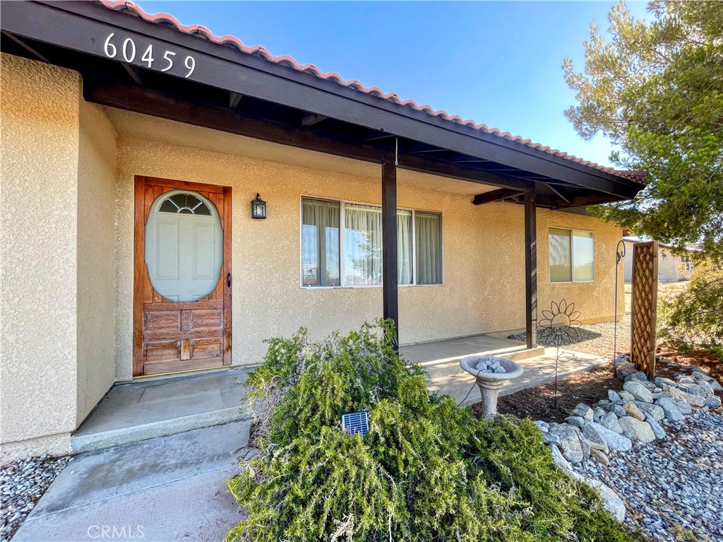 This beautiful Joshua Tree home features two spacious bedrooms, two full bathrooms, and a bonus room off the kitchen. It is located on a corner lot with a circular driveway and a side garage entrance. The backyard is fully fenced and invites you to soak in the beauty of the outdoors. This property is conveniently located near the vibrant heart of downtown Joshua Tree and the breathtaking landscapes of the world-famous Joshua Tree National Park. This makes for a perfect retreat for those seeking inspiration and adventure.
