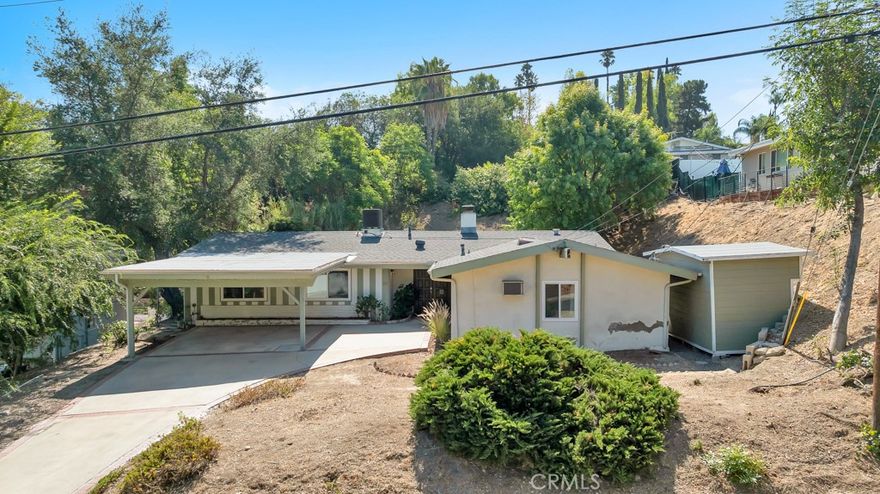 Welcome to this spacious Carlton Terrace pool home! This 4-bedroom, 2-bath, 2,125 sq. ft. single-story ranch offers endless opportunities to make it your own. Step through the bright double-door entry into a foyer that opens to generous living spaces, including a large eat-in breakfast nook, U-shaped kitchen with quartz countertops and bar, formal dining room, a living room with floor to ceiling brick fireplace, and an additional family room created from the permitted garage conversion. Vaulted ceilings in the living and dining areas enhance the open, airy feel while providing views of the sparkling pool and spa.



The bedroom wing features four rooms with vaulted ceilings, including a primary suite with dual closets and a walk-in shower. Additional highlights include a tasteful storage shed in the side yard, an enclosed bonus storage area off the family room, and a convenient laundry closet located in the family room. A attractive carport provides shade and protection for your vehicles.



Ideally situated, this home is close to shopping, dining, and offers easy access to the 101 freeway.