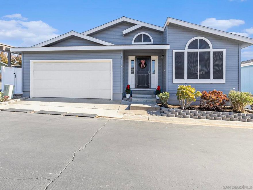 Come and see this beautifully fully remodeled home offering over 1400 sq. ft. of living space! This charming manufactured home features a two-car garage and a fully fenced backyard, and it truly shows like a model. From the moment you enter the wide hallway with cathedral ceilings and elegant lighting, you’ll feel right at home. The fully upgraded kitchen is both charming and functional, featuring soft-close cabinetry, custom slide-outs, stainless steel appliances, and a delightful breakfast nook. (refrigerator included)., and beautiful  countertops. This home combines beauty with comfort—featuring engineered hardwood floors, remodeled bathrooms, ceiling fans in every room, and heating and air conditioning. Custom double doors from the living room and primary suite open onto a spacious patio where you can relax and enjoy your morning coffee. The backyard is fully fenced and perfect for gardening or outdoor fun activities. The spacious master bedroom includes a walk-in close! The community offers everything you could wish for: a clubhouse with a movie area and pool tables, a remodeled event kitchen, a refreshing pool with a kiddie pool and jacuzzi, a gym, playground, and available RV storage (subject to availability). This is a Family Park!  Truly a home that checks every box!  Come and see this beautifully fully remodeled home offering over 1,500 sq. ft. of living space! This charming manufactured home features a two-car garage and a fully fenced backyard, and it truly shows like a model. As you enter through the front door, you’re greeted by a wide, open hallway with cathedral ceilings and a stunning hanging light fixture. To your right is the completely remodeled kitchen, featuring soft-close cabinets, a custom spice rack, pantry slide-outs, and an abundance of storage for all your appliances. The kitchen includes all stainless steel appliances, including the refrigerator, and offers a cozy nook for a small table, while the adjacent dining area easily accommodates a larger dining set. The home has been tastefully decorated and features beautiful engineered hardwood flooring throughout. There are three bedrooms and two fully remodeled bathrooms with updated countertops. All bedrooms—and the living room—are equipped with ceiling fans for added comfort. The living room and master bedroom both feature custom double doors leading to the outdoor patio. The living room and master bedroom both feature custom double doors leading to the outdoor patio. The spacious master bedroom includes a walk-in closet, and the large patio is the perfect place to enjoy your morning coffee. The backyard offers plenty of space for gardening or outdoor activities. The property also features heating and air conditioning. The Community clubhouse offers fantastic amenities, including a movie-watching area, a pool table for fun with family and friends, and a large remodeled kitchen available to rent for parties and events (with deposits returned the same week). In the summer, enjoy the refreshing pool area, complete with a kiddie pool, jacuzzi, and ping-pong table. Additional amenities include a gym, a children’s playground, and RV storage (subject to availability)