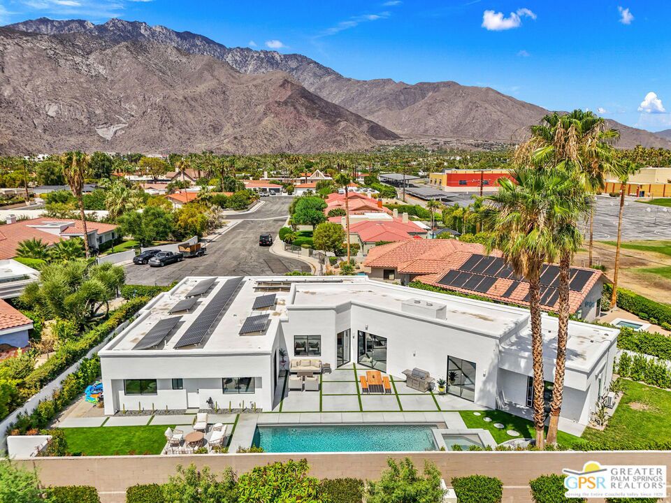 Price Reduced! A fully remodeled modern home with 12 ft. ceilings and fun surprises around every corner. Your private oasis awaits in this walled estate which was fully renovated in 2024 with the finest finishes. This home boasts incredible views of the San Jacinto mountains and is just a stones throw from Downtown Palm Springs. Every inch of this 3,162 sq. ft. home has been reimagined and upgrade with modern finishes, custom 3D wall features and inlayed LED lights. Sitting on a large 10,890 SF flag lot at the end of a double cul-de-sac this home features 4 oversized bedrooms and 3.5 bathrooms. Upon entering the gated courtyard, you're welcomed into a private lawn and lush gardens. Once inside, the bright and vast open area invite you through the living, dining and a custom open-concept kitchen, perfect for entertaining. The rooms look out into your private backyard with a pool, spa, all new hardscape and landscaping with a mixture of natural and artificial turf. All windows have custom electronic treatments, and all devices and exterior lights are set for a smart house. The primary suite is your sanctuary which features a large modern bathroom double vanity, large walk-in rain and standard shower heads with a huge soaking tub and smart toilet. Off the primary is a custom built walk-in closet and office that perfectly utilizes the available space and offers ample storage. Now is your chance to experience luxury modern living in one of the most sought-after locations in Palm Springs!
