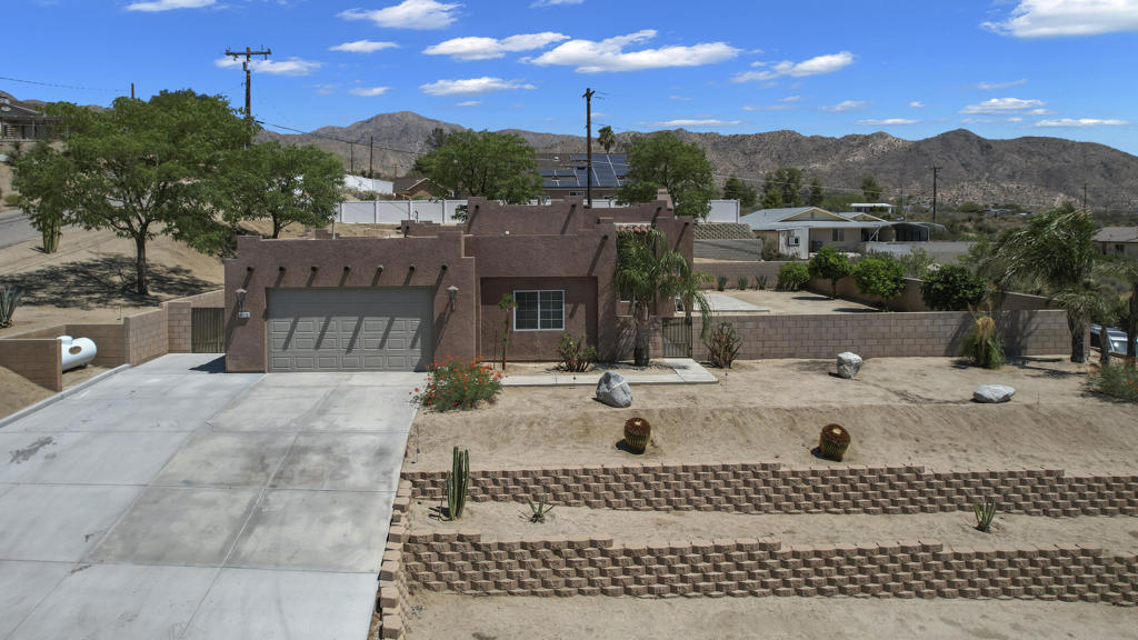 Wow!!! Check out the views!!! This hilltop custom home now available due to a job transfer to Phoenix. Now your opportunity to own one of the nicest homes in Morongo Valley. ! 3 bedroom 3 full baths, (all en suites) great room concept with fireplace makes this a great floor plan. Oversized two car garage (attached) with custom outdoor lighting, and tiered landscape takes you up to this elevated home. Over 2100 well appointed square feet with a massive yard, fruit trees and patio. On the other side is a dog run for your puppies! Easy to show text card and GOOOO!