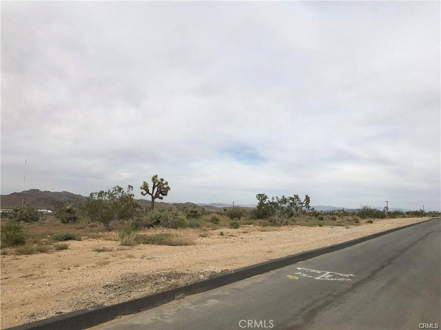 Fantastic 5-acre commercial parcel located right at the border of Joshua Tree and Yucca Valley. Situated on a busy thoroughfare with a three-way stop, the property experiences steady traffic flow. Zoned Industrial, it’s ideal for a wide range of commercial or development uses. Water, power, electric, and sewer are located nearby, providing convenient access for future development.