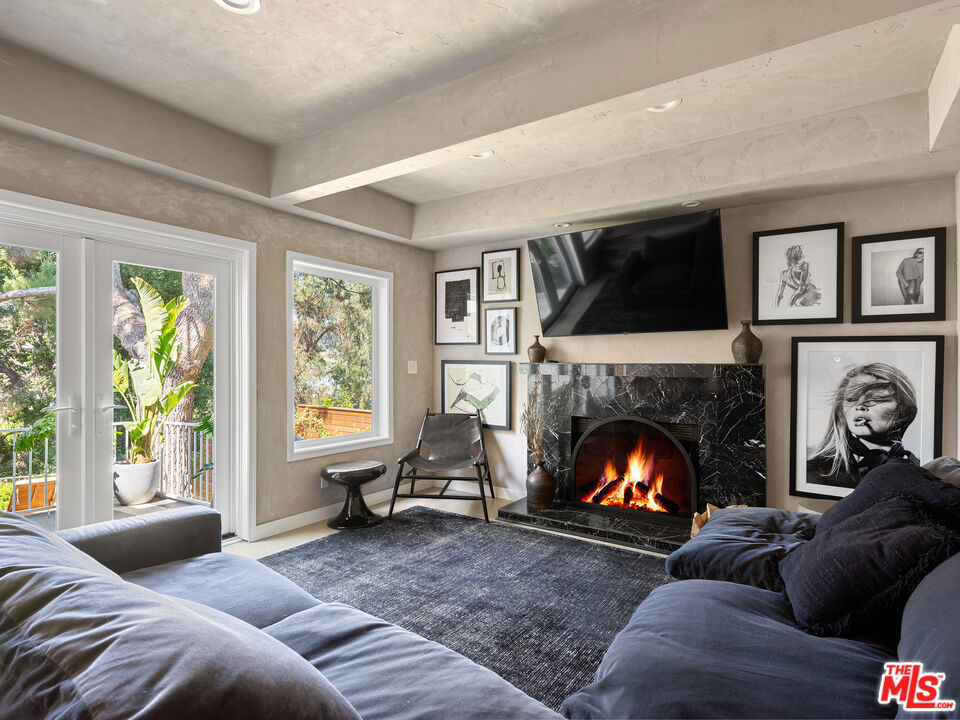 There are homes you live in, and there are homes that TRANSFORM how you live. Designed by celebrity stylist Dani Michelle (Hailey Bieber, Kendall Jenner, Kourtney Kardashian, Elsa Hosk) with interiors by design icon Leanne Ford, this fully furnished sanctuary, featured in Domino Magazine, offers a rare opportunity to lease an architectural gem in the heart of the Hills. Throughout the home, materials and textures create an immersive sensory experience. Venetian plaster walls, sueded marble, whitewashed stone, oxidized steel, sculptural built-ins, vintage lighting, hand-painted surfaces, natural textures, and layered vintage tones. Every surface and finish responds to the shifting light and rhythm of the day. The layout offers four bedrooms (including a fully custom dream closet), four baths, and expansive indoor/outdoor living spaces designed for connection and ease. The elevated chef's kitchen, complete with a built-in Italian cappuccino maker and dining for twelve, opens to living areas that transition effortlessly from day to night.From sun-soaked mornings to golden hour canyon views to cozy evenings on the oversized RH Cloud Couch, the home offers a dynamic canvas for daily life and entertaining.Outdoor spaces evoke the spirit of the Greek isles. Olive trees sway above hand-painted terraces, while an oversized globe pendant anchors the dining area, setting the tone for long dinners and intimate gatherings. A private grass backyard provides a rare layer of outdoor space in the Hills. A finished garage, with HVAC and its own patio, adds flexible space for a studio, gym, or creative office. Additional features include full smart home integration (Nest, Ring, Frame TVs, B-Hyve watering system), gated entry, drought-tolerant landscaping, and a full suite of bespoke furnishings, including Fendi Home, Olive Atelier, Restoration Hardware, rare art, and curated accessories, all ready to be lived in. Leasing a fully designed home by two of LA's most visionary curators, an internationally celebrated interior designer and a globally recognized stylist, is an extraordinary offering. For those who value beauty, creativity, and elevated living, this is one of the most coveted homes to lease in Los Angeles.