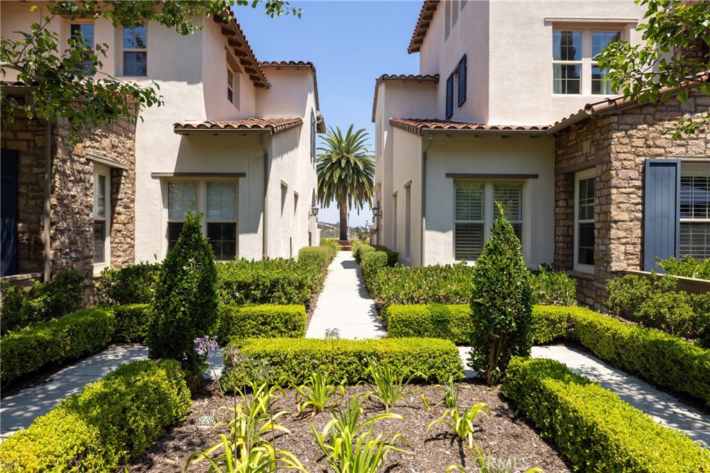 Welcome to a refined coastal sanctuary in the coveted community of Ziani, Newport Coast—where timeless elegance meets the relaxed allure of seaside living. Perfectly positioned in a prime location as a tranquil end-unit, this residence features Ziani’s largest floor plan, filled with natural light from multiple exposures and graced with soft ocean breezes and peek-a-boo views of the Pacific. At the heart of the home, the kitchen boasts quartz countertops, top-tier appliances, and temperature-controlled wine storage—equally suited for casual mornings or elevated dinner parties. From here, step out to your spacious patio, perfect for morning coffee, alfresco dining, or evening conversations beneath the coastal sky. The adjacent living room, anchored by a striking fireplace, opens to a covered patio overlooking lush gardens. Three soothing bedrooms, including a stately primary suite with spa-inspired finishes, provide restful havens at the end of the day. Upstairs, an enclosed bonus room offers ultimate privacy—ideal for a work-from-home office, guest retreat, playroom, gym, media center, art studio, or den. Residents of Ziani enjoy secure gated access and a short stroll to resort-style amenities, including a saltwater pool, spa, lush gardens, putting green, and nearby scenic trails that wind toward breathtaking overlooks. Just minutes from Crystal Cove, world-class shopping at Fashion Island, pristine beaches, championship golf courses, acclaimed dining, and John Wayne Airport, this home presents a rare opportunity to embrace a coastal Riviera lifestyle—where luxury and leisure meet in perfect harmony.