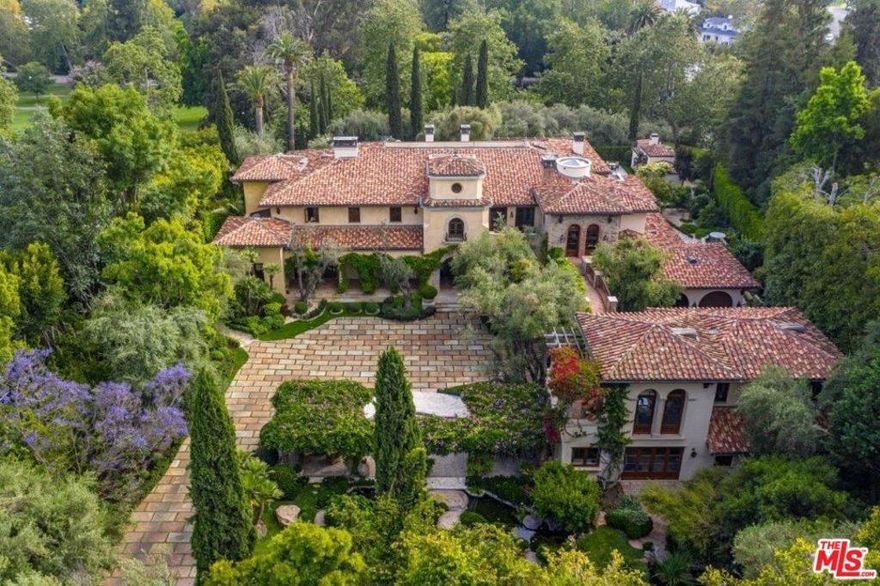 Romantic villa masterpiece conceived by Robert Sinclair & Mark Boone displays unrestrained beauty, craftsmanship & volume. Behind gates, an olive tree lined drive leads to motor court surrounded by trees, koi ponds, pathways & tranquil gardens.  1.3 flat acre compound encompasses 5b, 8ba, 4powders & 2maids in main house & 2-story GH. Dramatic foyer. Grand scale FLR w/ fp. Exquisite library w/ coffered ceiling, fp & office w/ terrace to grounds. FDR enchants w/ wrought iron arched windows/doors. Family room w/ bar & soaring ceiling. Chefs kitchen w/ brick ceiling, island & breakfast rm. Downstairs wine cellar, lounge, bar, screening rm & billiard room. 2nd floor master suite w/ vaulted ceilings, marble fp, 2 terraces, 2ba suites, expansive walk-ins, dressing & sitting rm. 4addtl bd suites upstairs. Undulating bridge to 1bd/2ba GH w/ gym & sauna. Addtl luxurious amenities: ample parking, elevator, pool, spa, outdoor kit & security. The Mapleton Villa awaits its next illustrious owner.