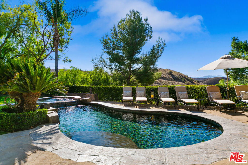 This fully furnished residence, nestled within the prestigious Valley Circle Estates of West Hills, offers unobstructed views of the Upper Las Virgenes Canyon Open Space Preserve (formerly Ahmanson Ranch). Perfectly positioned, this rare plot of land captures breathtaking vistas of untouched wilderness stretching from West Hills to beyond Paramount Ranch, with no other homes or structures in sight. The serene residence grants direct access to the majestic 5,600-acre Preserve, an essential ecological and wildlife corridor linking the Santa Monica Mountains to northern ranges. Enjoy a daily kaleidoscope of color from every vantage point: begin your mornings with gentle sunrises over the valley from the east-facing rooms, and end each day captivated by spectacular sunsets from the west-facing rooms and luxurious primary suite. This 5-bedroom, 4.5-bathroom estate effortlessly blends spa-like luxury with the tranquility of nature. The interiors were meticulously curated by a renowned interior designer who dedicated over two years sourcing custom-made and imported pieces from Africa, Europe, and Asia. The home is further enhanced by modern conveniences, including a state-of-the-art smart home system. Beyond the sundeck lies lush hillside grounds already flourishing with a charming garden, citrus trees, and established grapevines. With ample remaining land, your creative possibilities are endless whether it's your own private orchard, a peaceful meditation sanctuary, or even a sport court. Framed by sweeping views overlooking the Preserve, this extraordinary property is a blank canvas limited only by your imagination.