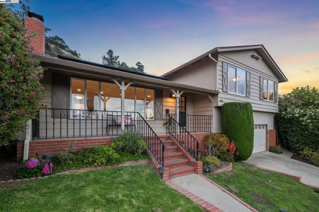 With bay views and the East Bay hills as your backdrop, this upgraded 4+BD/2.5 BA Mid-century home offers comfortable living in the Crestmont. Set back from the street, the 1785 SQFT home welcomes you with a garden and a rare level lawn in the hills. A giant picture window and fireplace make the spacious living room a cozy place to relax. Wonderful flow leads to the kitchen and dining room. The renovated eat-in kitchen features a double oven, stylish sink, and breakfast nook. From the dining room, step through a sliding glass door for great indoor/outdoor living on the patio. With lemon trees, raised beds, and open hillsides, it’s a perfect place to unwind, entertain, or play. Back inside, the four bedrooms are tucked away on the second floor for quiet and privacy. With two large custom closets, an ensuite bath, and hillside views, the primary suite is a refuge. Two of the bedrooms enjoy bay views and all have roomy closets. They share a hall bath. The refinished lower level provides excellent flexible space as a comfortable den, office, or play room. There’s also a laundry room, powder room, indoor access to the 2-car garage, and glass doors to the patio. Out your front door, explore the East Bay parks’ miles of trails and vibrant Montclair nearby.