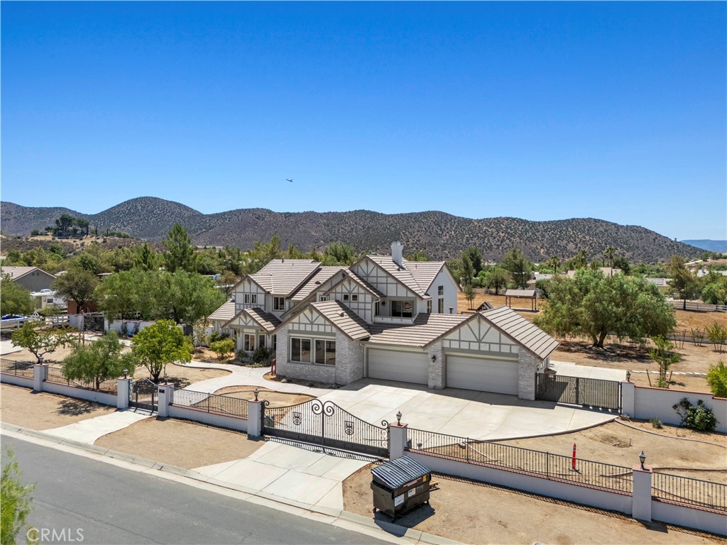 An Elegant Sierra Colony Estate on Two Flat Acres!
Set in the coveted Sierra Colony community, this refined residence offers nearly 4,200 square feet of thoughtfully designed living space on two flat, fully usable acres—perfect for equestrian pursuits, gardening, or a car enthusiast’s dream collection. Every detail blends timeless architecture with modern comfort.
The main level features stunning engineered hardwood floors, a guest bedroom with private bath, a dedicated home office, and a versatile media/game/library/school room within its own private wing that can easily serve as a second guest suite. A spacious laundry room with ample storage and a sink that connects directly to the expansive four-car garage.
At the heart of the home is a gourmet chef’s kitchen boasting a deluxe butcher block island, porcelain countertops, breakfast bar, charming bay-window dining nook, mini butler's pantry, Sub-Zero refrigerator, professional 6-burner gas range, and stainless steel appliances.
Upstairs, three spacious bedrooms provide peaceful retreats, including the luxurious primary suite with cathedral ceilings, a fireplace, a sitting area, a private balcony, and a spa-inspired bathroom featuring dual porcelain vanities, a relaxing spa tub, and a free-standing glass shower.
The gated and fully fenced grounds include a steel-covered area, a container storage, a wood storage shed/tack room, a basketball court, and a children’s play area—plus vast open space for stables, gardens, workshops, and more. All just moments from Agua Dulce Vineyards, this estate offers the perfect balance of upscale living and country freedom in one of Agua Dulce’s most desirable locations. No HOA or MELLO ROOS