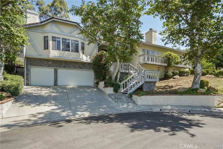A stunning 4,050 sq ft. 4 Bedroom, 5 Bath home, that sits on a large lush ½ Acre lot at the end of a quiet Cul-de-sac in the highly coveted Roy Rogers Estates.  Tucked away in the foothills of Chatsworth, close to awarding winning schools, Popular restaurants, entertaining and shopping. Freeway access is also close by. This tranquil Oasis is ideal for raising families and entertaining guests alike. Open the tall beautifully stained Double doors to a large foyer entry where you will find high ceilings and beautiful wood floors that lead you into a thoughtfully laid out floor plan. There is a chef's kitchen with lots of windows and natural light that features newer top of the line appliances and eating area, perfect for family meals. The kitchen opens up to an exquisite formal dining room. There is a huge cozy family room with a wet bar, gas fireplace, vaulted wood ceilings and large Bay window to fill the room with sunlight, step down to the formal living room with French doors, balcony, gas fireplace to entertain your guests. Just across the entry is a Wood Panel Parlor room with beamed ceilings, perfect for a grand piano and sitting area. The master bedroom is oversized with French doors opening up to your private balcony. There’s good size dressing area with a cedar closet and spa style bathroom with huge built-in jacuzzi tub and large glass shower. Bedroom #2 opens to the backyard & hillside it features a large closet and full bath. Bedroom #3 is light and bright with large closets, double sinks and full bath. Bedroom #4 or the “Loft” has its own private staircase that leads to a larger room with wood floors, walk in closet and three quarters bath. This room is versatile and could be anything your heart desire theater, bonus room, etc. The 5th bathroom is a guest powder room perfectly located in the hallway between the kitchen and the wet bar. The home also has a three-car garage with ample storage area. The lush yard is peaceful & private, with mature trees, lots of plants and decking, perfect for barbecues and family entertaining. There is an in-ground spa for relaxing. This home is “one-of-a-kind” offering, country charm and classic elegance with modern appliances making it ideal for families and entertaining alike, call and make your appointment to see before it's gone