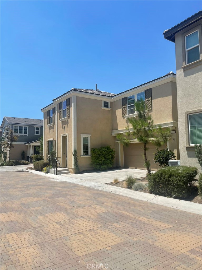 This beautiful 4 bedrooms and 3 baths, featuring a spacious master bedroom suite. SOLAR panel installed, Individual laundry room. The gourmet kitchen boasts a large center island, quartz countertops, stainless steel appliances, and ample cabinetry, opening seamlessly to the dining and living areas—perfect for entertaining. Upstairs, the luxurious primary suite includes a spa-inspired bathroom with dual vanities, a walk-in shower, soaking tub, and a generous walk-in closet. Two additional bedrooms, a full bathroom, and a laundry room complete the second level. First floor has 1 bedroom 1 bath, great for a guest. Two car garage. Great community amenities include community pool, spa, clubhouse and park. Perfect location for shopping, close to Ontario Mills Mall, easy FWY15 and FWY60 access. This house is highly suitable for all families.
