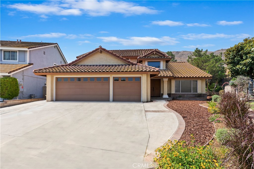Welcome to this inviting and culdesac-situated Lake Hills home with a 3-car garage (w/ 240 volt electric car charger) where style, space, and function come together beautifully. Located on at the very end of the culdesac, this thoughtfully designed property offers an ideal layout for everyday living and entertaining — perfect for families, multigenerational households, or anyone who loves to host. Step inside to soaring ceilings and laminate wood floors that add warmth and character throughout the main living areas. Abundant natural light filters through double pane windows, enhancing the airy feel in both the formal living and dining rooms. The centrally located kitchen is the heart of the home, featuring granite countertops, stainless steel appliances, and a dining area that opens to a spacious family room with a cozy fireplace — a perfect setup for movie nights or casual gatherings. A downstairs bedroom and full bath offer flexibility for guests, in-laws, or a private home office with a laundry just down the hall. Upstairs, you'll find three additional bedrooms and a generously sized primary suite with a walk-in closet and a private bath. Outdoors, the backyard is private and green which can be can be enjoyed from the shade of the alumawood patio cover with two ceiling fans. Nestled on 750 acres, Lake Hills provides a serene mountaintop retreat near Riverside’s cultural and educational offerings as well as shopping. Residents enjoy the vast open spaces, top-tier Lake Hills Elementary, parks, playgrounds, picnic areas, and a basketball half-court. The HOA also includes maintenance of the extensive common grounds as well as an evening security patrol. Perfect for commuters, with easy access to the 91 Freeway and Metrolink.