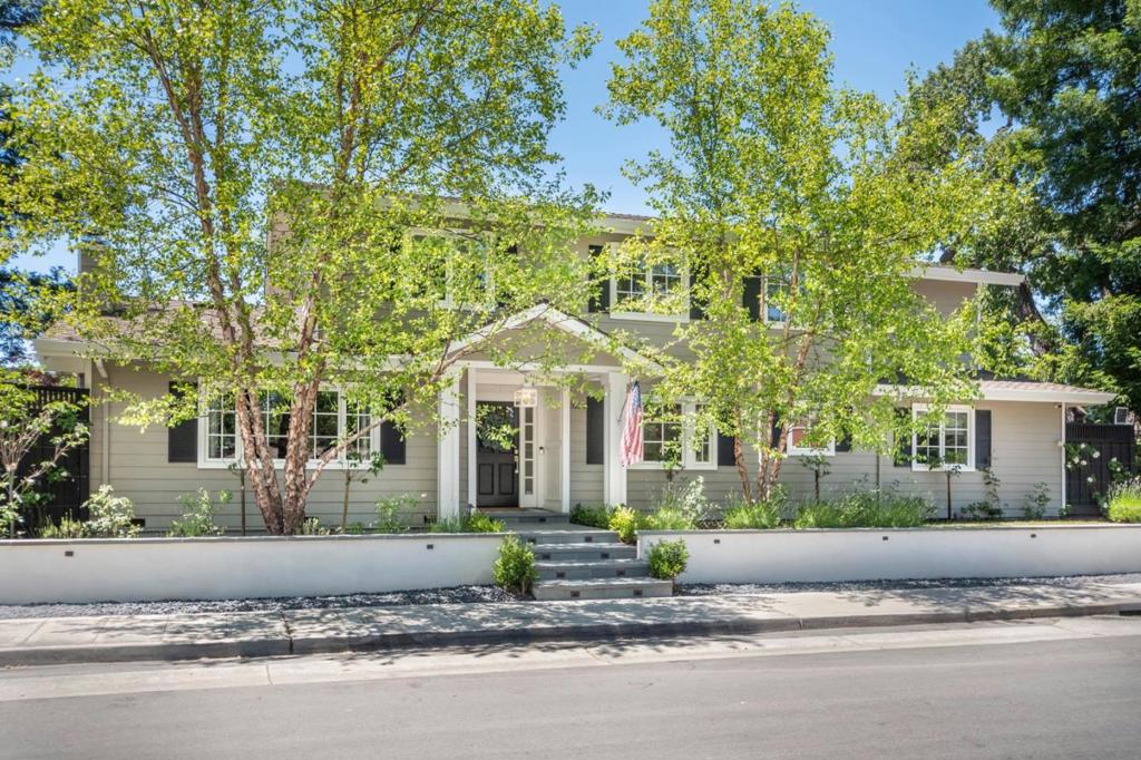 This stunning Menlo Park home,situated on a corner lot with meticulous landscaping, impresses with its exterior charm and masterful design. Upon entering, the elegant floor plan features a handsome living room with a fireplace and formal dining room. Design elements continue throughout: wainscoting, custom moulding, hardwood flooring, picture windows. The hallway extends to the family room/kitchen with a vaulted tongue and groove ceiling and doors that open to the yard. A chef's kitchen delight with stone countertops, high end Viking appliances, island, banquette seating, and butler's pantry that has a dedicated office space! The first floor boasts an ensuite bedroom with a renovated bathroom, walk-in closet, private yard and separate entrance. Also found on first floor is a private office with yard access. The second floor comprises three bedrooms, two bathrooms and a laundry room. The primary has a remodeled bathroom that includes a soaking tub, stall shower, double vanities and specialized cabinetry. The yard astounds with its high-end outdoor kitchen, dining space, lawn and deck running along side the home, ideal for indoor/outdoor living and entertainment. Award winning Las Lomitas school! County records show 3116 sq ft. Floor Plan Visuals show over 3200 buyer to satisfy
