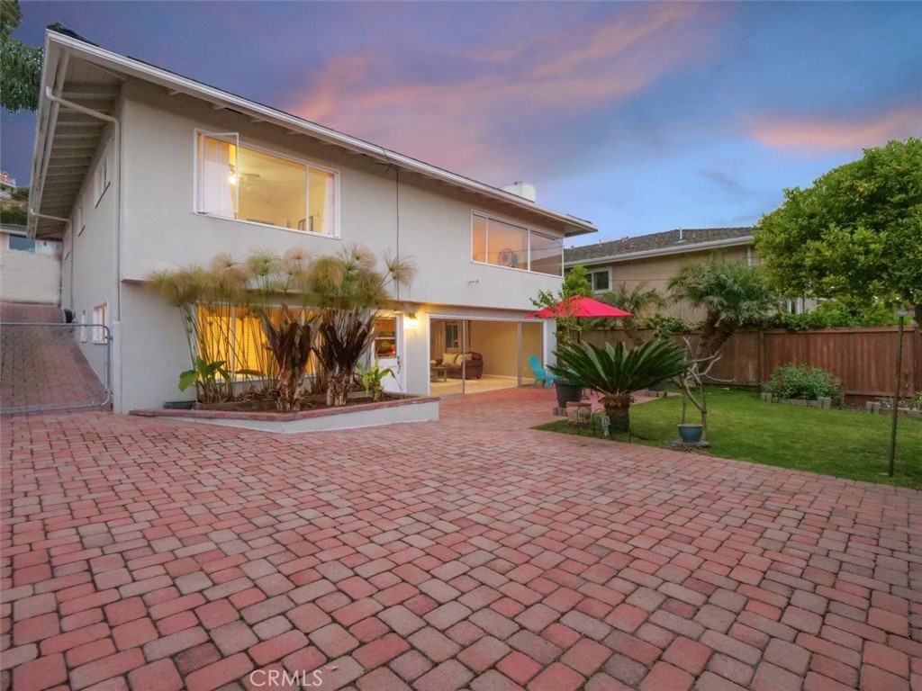 Welcome to this beautifully updated Lunada Bay gem, ideally situated in one of the most sought-after neighborhoods on the Palos Verdes Peninsula. Thoughtfully maintained and full of character, this home offers an exceptional blend of comfort, coastal charm, and everyday functionality.
Step inside to discover a warm and inviting interior, featuring sand-colored oak wood flooring, designer paint, and expansive windows that bathe the home in natural light. The spacious living and dining area is anchored by a cozy fireplace and showcases peek-a-boo ocean views, creating a relaxing atmosphere that’s perfect for both everyday living and entertaining.
The kitchen has been tastefully updated with granite countertops, stainless steel appliances, and under-cabinet lighting, ideal for the home chef. Just off the entry, a lushly landscaped and private front patio offers a serene setting for al-fresco dining, reading, or gathering with friends.
This versatile layout features two generously sized bedrooms and a full bathroom upstairs. Downstairs, you’ll find a large family room, a third bedroom, and a second bathroom, perfect for guests, a home office, or multigenerational living. The family room opens to a patio that leads to a large, grassy backyard with raised flower beds, perfect for gardening, relaxing, or play.
Additional highlights include a detached two-car garage, a long paver driveway, and a prime lot that offers privacy and plenty of sunlight throughout the day. Located near top-rated schools, including Lunada Bay Elementary, Palos Verdes Intermediate, and Palos Verdes High. This home is the ideal setting for those seeking a tranquil lifestyle with convenient access to parks, schools, and the coast.
Don’t miss the opportunity to make this exceptional home yours!