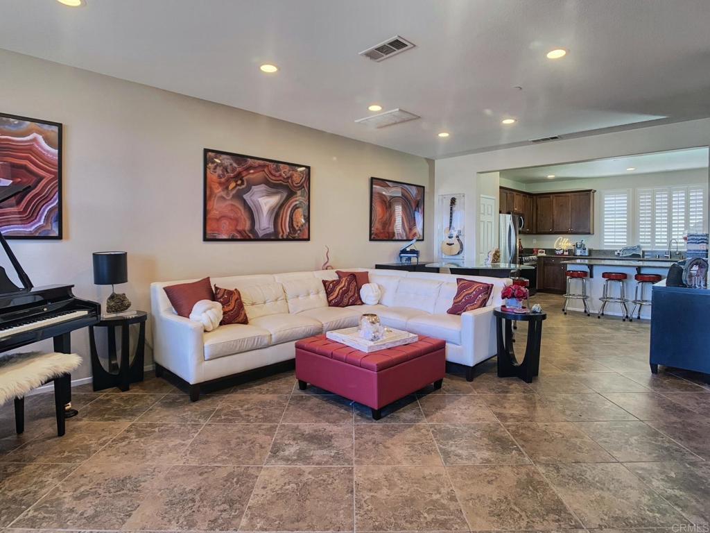 GORGEOUS TURN KEY TOWNHOME IN SKYRANCH. Stylish & Smart Living with Views! This beautifully updated 3-bedroom townhome features three private bedroom suites with their own full bathrooms, 2 with large walk in closets, each with custom upgrades. Enjoy breathtaking mountain views from the open-concept great room and smart-lit balcony with color-changing café lights—perfect for entertaining! The home boasts LED lighting throughout, laminate flooring, smart thermostat, Ring doorbell, and new paint (2023–2024). The modern kitchen includes stainless steel appliances (2022), built-in wine fridge, and stylish finishes. All bedrooms feature smart fans, blackout blinds, upgraded bathrooms, primary suite includes gorgeous electric fireplace with color/heat settings. Bonus perks: Smart washer/dryer, smart garage door, 5 premium storage racks, and resort-style community amenities—pool, spa, clubhouse, dog park, hiking & biking trails. Move-in ready, modern, and energy-efficient with views!