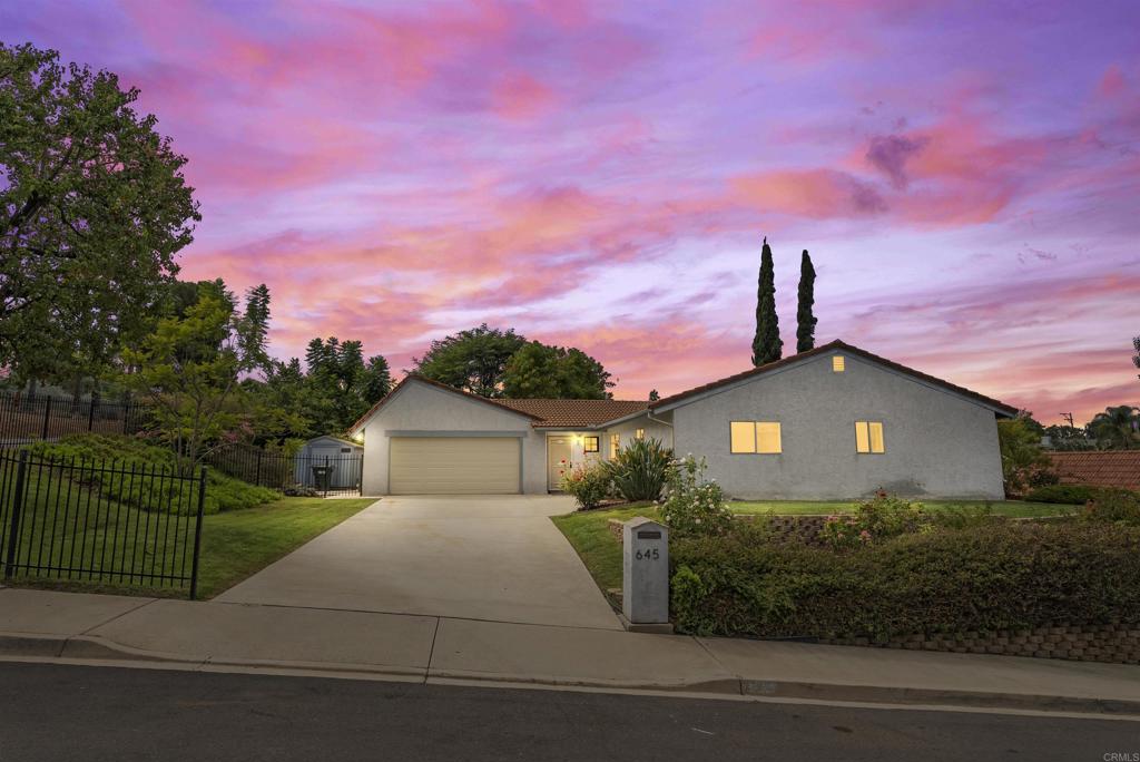 This charming single story corner unit offers comfort and privacy on a quiet street. Features include a classic clay tile roof, carpet and tile flooring, an open kitchen and dining area, and a cozy fireplace perfect for relaxing evenings. The home also includes a spacious laundry room and a peaceful backyard surrounded by mature landscaping ideal for outdoor enjoyment. Conveniently located near North County Mall, Kit Carson Park, and Palomar Medical Center, with schools like Orange Glen Elementary, Hidden Valley Middle, and Orange Glen High just minutes away, this home combines everyday comfort with easy access to shopping, dining, recreation, and top local amenities.