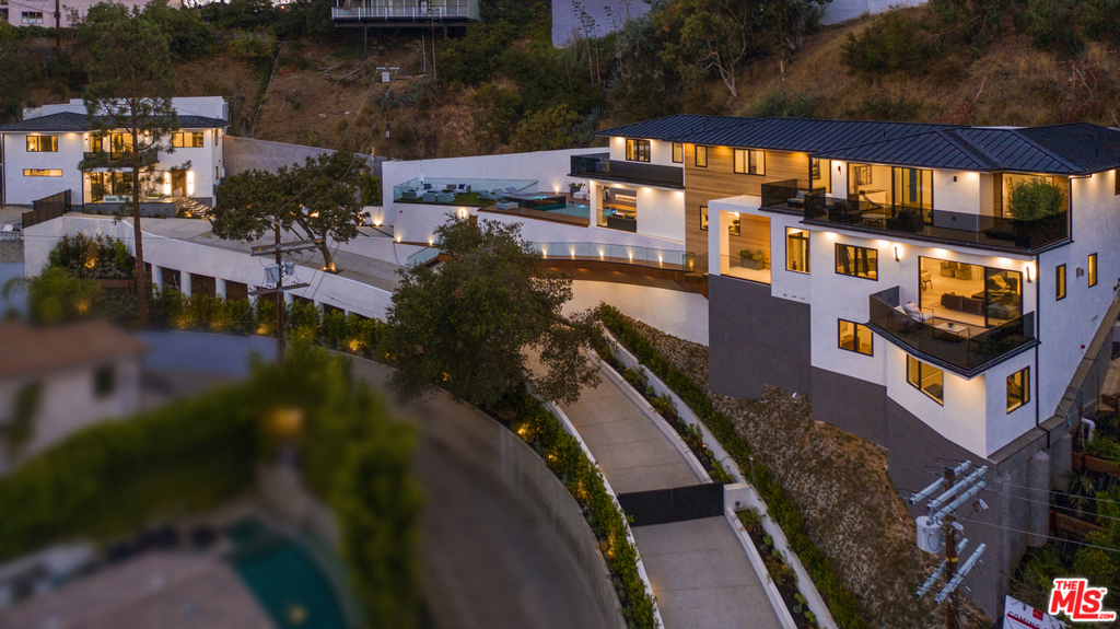 Presenting the triumph of luxury view estate this custom-built design-forward masterpiece offers impeccable modern finishes with a minimalist aesthetic joined with city views in the celebrity enclave of Sunset Strip. This trophy residence is the pinnacle of sophisticated living, with a compound presence and approximately 250-foot gated driveway with multiple private parking spaces, a rarity in this area. The property also includes a rare fully loaded near the 1,700-square-foot detached guest house, the perfect addition to complete your wish-list of amenities and flex spaces. Treat your loved ones to memorable movie nights in the jaw-dropping media room, or simply lounge by the zero-edge pool while enjoying the most scenic views. Workout in the large gym and relax in your own sauna. Culinary creations made easy in the striking sleek kitchen with top of the line Miele appliances. Decompress in the luxurious and view-filled master retreat. This estate is not to be missed.