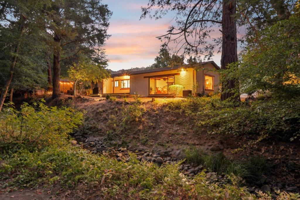 Welcome to your own private retreat located on the prestigious South County Wine Trail. Drive through the heart of Gilroy's picturesque countryside to this 2bd / 1ba haven nestled amongst majestic redwoods that tower over your share of Murphy / Little Arthur Creek which flows year round. This stunning home offers the perfect blend of country and modern living with a spacious 1,832 sq. ft. This custom built home was majorly remodeled in 2024. The open layout features a gourmet kitchen with all new appliances, spacious living areas, open beam ceilings, and expansive windows showcasing breathtaking nature views. Enjoy the 2.1 acres with tons of possibilities & amenities galore including a creek side firepit, a hot tub for relaxing under the stars and a covered gazebo for entertaining. This secluded gem also boasts a 2 car garage that can be used for office or game room. Walking distance to renown wineries and just a few minute drive to Martin Ranch, Kirigin Cellars, and Fortino Winery. Its just a short drive to Gilroy's vibrant downtown, outlets, top-rated schools, and Highway 101. This home offers a rare opportunity to enjoy peaceful privacy in the beauty of wine country.