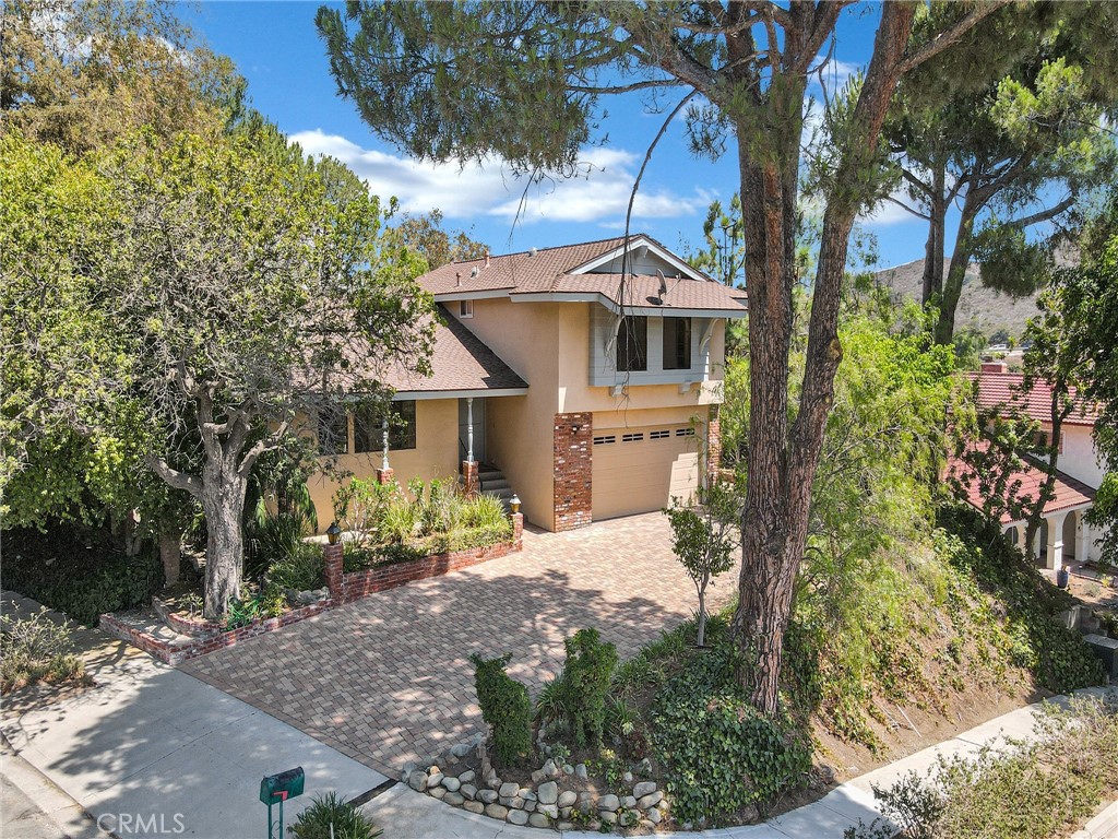 Come see this stunning home that has been beautifully remodeled and upgraded to appeal to the most sophisticated buyers. Enjoy resort-style living with an indoor 6-person spa, open concept living, dining & sleek kitchen that impresses with quality appliances, granite countertops, solid wood custom cabinetry, a large island, and art niches throughout that add to your new home’s elegant style. New luxury vinyl floors in den with antique mantel surrounding brick fireplace and tv cabinet and living room off of formal entry with new luxury vinyl floors and built in floor to ceiling bookcases plus 2nd fireplace with antique mantel. Save on electric costs with solar panels and tesla powerwall so you have light and power at all times. This character-filled split-level home offers flexibility and comfort, and is tucked away on your own quiet cul-de-sac. It is a must-see move-in ready home that offers a serene view of pine trees and the hills beyond from inside and from your fully fenced back yard and pavered patio with 2 fountains, plus covered porch. Come home and turn into your pavered driveway to your spacious 2 car garage with opener, 2 work areas, loads of storage cabinets, and laundry area. Located in beautiful Sunset Hills, adjacent to the country club that offers a golf course, clubhouse, fine dining, pickleball & tennis courts.