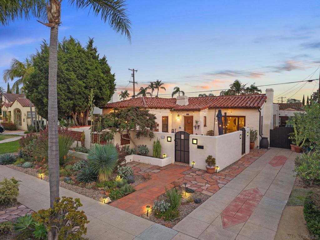 Welcome to this quintessential 1930 Spanish gem located in the heart of Kensington, just steps from the vibrant charm of Kensington Village. Rich in character and timeless detail, this single-level home offers 3 bedrooms, 2 bathrooms, and 1,607 square feet of thoughtfully preserved and updated living space—plus a detached 304 SF studio ADU with its own kitchenette and full bath. A serene, gated front courtyard welcomes you into the home and sets a tranquil tone. Inside, you’re greeted by original hardwood floors, soaring vaulted ceilings with hammered beams, and a grand fireplace that anchors the light-filled living room. Every room is bathed in natural light, highlighting the rich architectural details and warm atmosphere that make this home so special. The dining room features additional exposed wood beams and opens through a French door to a covered patio—ideal for relaxing or entertaining outdoors. The kitchen is as stylish as it is functional, with a beautiful center island, open shelving, and another set of French doors that lead directly to the patio, creating seamless indoor-outdoor flow. The primary bedroom offers two closets and garden views, while a secondary bedroom features its own en-suite bathroom, perfect for guests or a home office setup. Outside, the backyard is a peaceful retreat, complete with vibrant bougainvillea and lush landscaping. The converted garage studio is perfect as a guest space, rental, or creative retreat—complete with a full bath and kitchenette, offering flexibility and value in one of San Diego’s most sought-after neighborhoods.