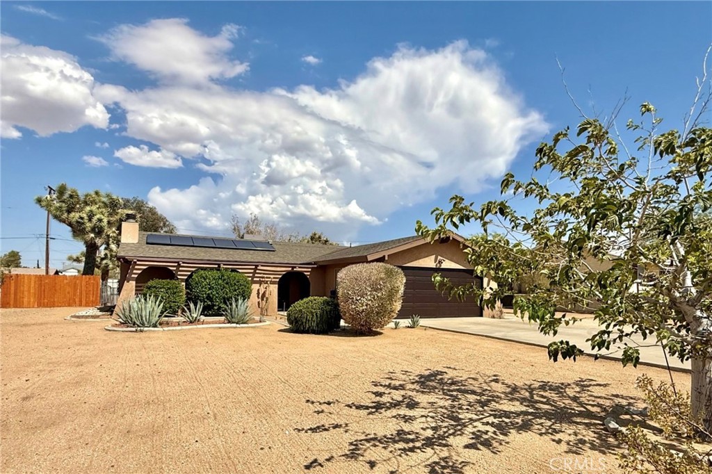 Come check out this lovely home in heart of Yucca Valley! This gorgeous 2 bed, 2 bath home sits on .41 acres with leased solar for energy efficiency and savings.
This home has been completely redone with modern touches and lots of charm. You'll not only enjoy one but 2 patios, one is a fully screened-in! Perfect for relaxing or entertaining. Once inside you'll find a spacious living room with a wood burning fireplace perfect for those cool desert nights, the kitchen has lots of storage with butcher block counter tops and newer appliances. There are two spacious bedrooms with large closets, in the primary bedroom you'll find your own ensuite bathroom with a large walk-in shower. Additionally you'll find covered RV parking with direct access to the garage.
whether you are looking for your perfect starter home or a retirement home, this is a must see!