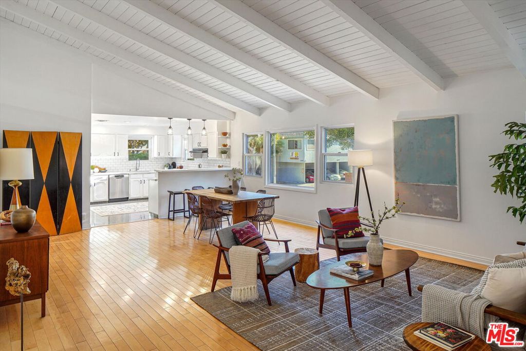 Nestled behind lush landscaping on a beautiful tree-lined street in the heart of Sunset Park is 1102 Maple St, an expansive Mid-century architectural with lots to love. This 4-bedroom, 3 bathroom home opens into the living and dining space with an extra high, wood-beamed ceiling that flows into a recently upgraded kitchen. Work out or work from home in the bright front office overlooking a beautifully maintained yard. Traveling through the primary bedroom with en-suite bath leads you to a huge family room with a floor-to-ceiling stone fireplace and plenty of space to relax. Outdoor dining and entertaining is a must on the very spacious rear deck, perfect for daytime hangs and twilight parties under the bistro lights. Moments from great schools, fine dining, and the beach this is Santa Monica living at its finest.