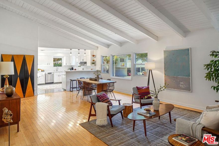 Nestled behind lush landscaping on a beautiful tree-lined street in the heart of Sunset Park is 1102 Maple St, an expansive Mid-century architectural with lots to love. This 4-bedroom, 3 bathroom home opens into the living and dining space with an extra high, wood-beamed ceiling that flows into a recently upgraded kitchen. Work out or work from home in the bright front office overlooking a beautifully maintained yard. Traveling through the primary bedroom with en-suite bath leads you to a huge family room with a floor-to-ceiling stone fireplace and plenty of space to relax. Outdoor dining and entertaining is a must on the very spacious rear deck, perfect for daytime hangs and twilight parties under the bistro lights. Moments from great schools, fine dining, and the beach this is Santa Monica living at its finest.