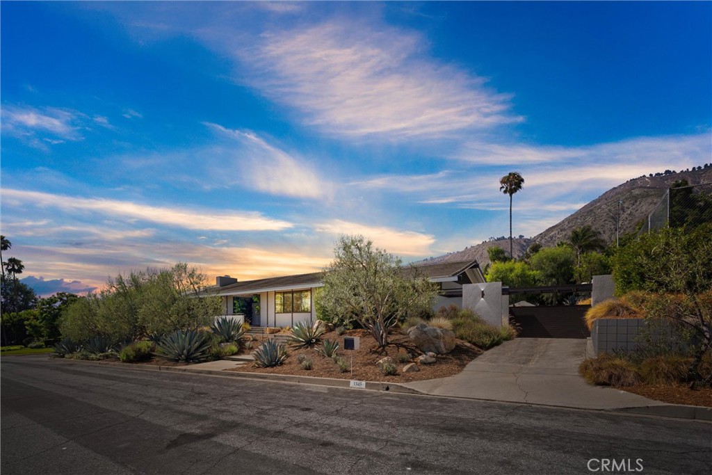 STUNNING MID-CENTURY MODERN OASIS IN THE HILLS! Discover the perfect blend of classic design and modern luxury in this exquisite mid-century modern home, originally designed by the preeminent architect Harold J. Bissner, Jr. Nestled on a sprawling 20,057 square foot lot, this exceptional residence offers 4131 sf of interior living space with 4 spacious bedrooms and 4.5 beautifully appointed bathrooms, making it ideal for both entertaining and everyday living. Step inside to find a captivating open floor plan adorned with walls of windows that flood the space with natural light, resulting in a seamless indoor/outdoor flow. The 2016 renovation, expertly executed by Catherine Johnson and Rebecca Rudolph of the acclaimed architecture firm Design, B_tches, features newer electrical, plumbing, windows, tankless water heater, and HVAC systems, ensuring both comfort and peace of mind. At the heart of the home is a gourmet kitchen that will delight any culinary enthusiast. It boasts sleek Italian cabinetry, elegant quartz countertops, and top-of-the-line appliances from Miele and Thermador. The generous 12-foot island provides ample space for cooking and casual dining, making it the perfect gathering spot for family and friends. Step outside to explore the beautifully landscaped grounds, designed by Terremoto. You will also find an outdoor deck, patio, sparkling pool and a private tennis/pickleball court—an entertainer's dream! The outdoor spaces offer endless possibilities for relaxation and recreation, surrounded by the stunning vistas of the hills. Experience the best of both worlds in this remarkable home, where mid-century charm meets modern sophistication. Don’t miss your chance to own this architectural gem in a coveted hillside location. Schedule your private showing today!